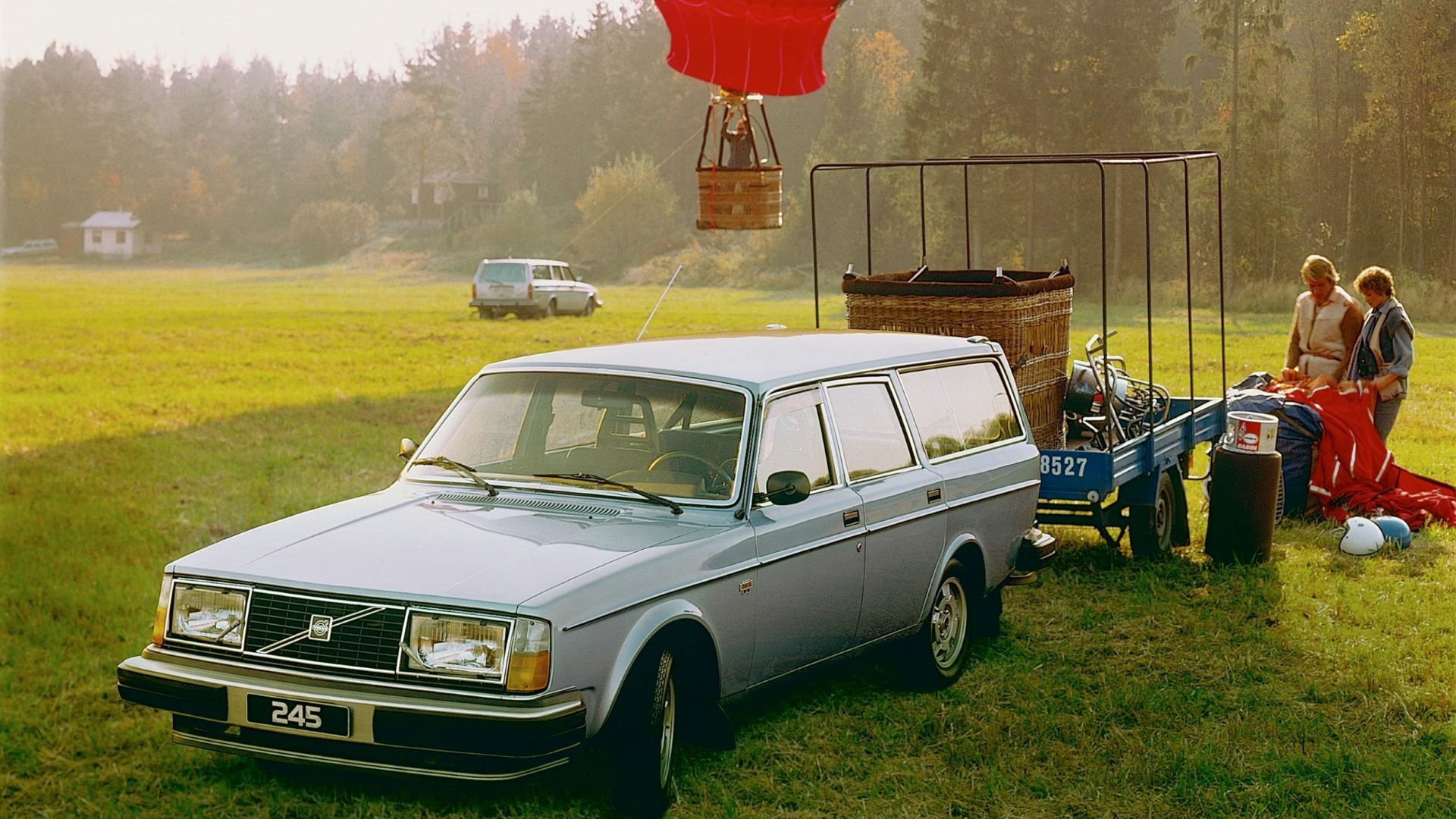 Front 3/4 shot of a Volvo 245 GL parked in a field