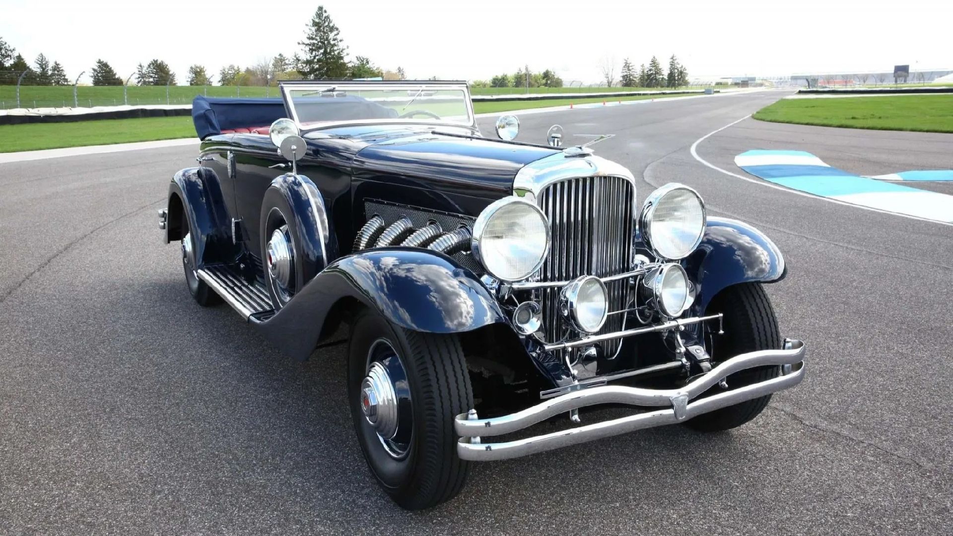 A black 1935 Duesenberg Model JN Convertible Sedan