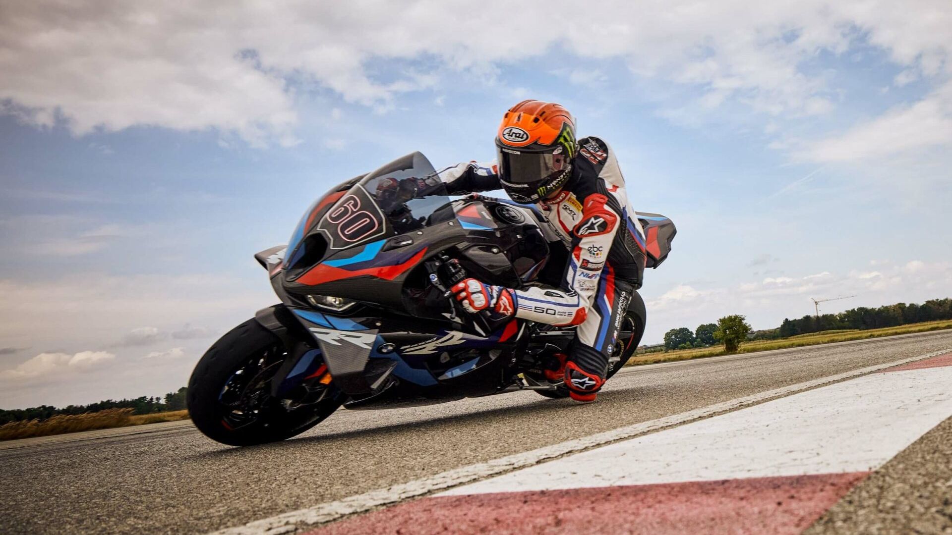 Black 2023 BMW M 1000 RR leaning into a curve