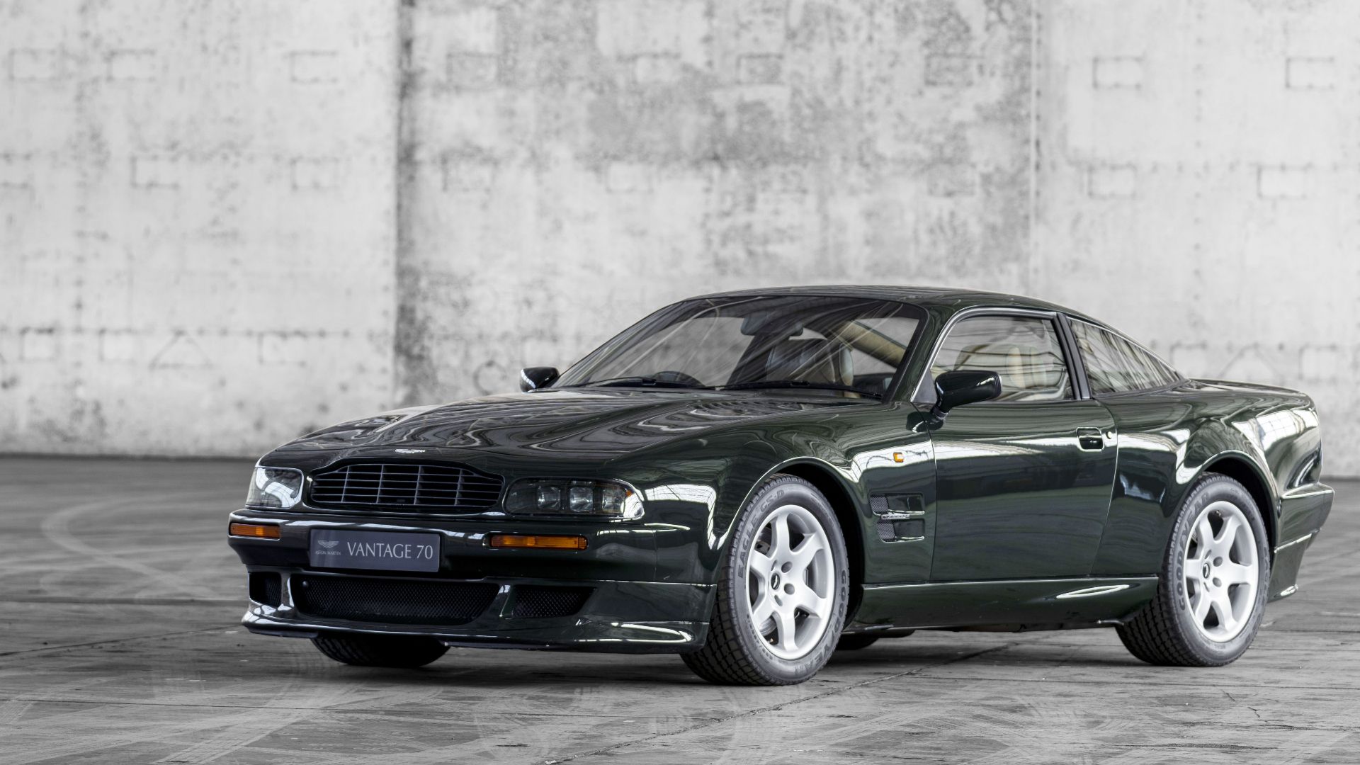 Front view British racing green Aston Martin V8 Vantage V550 parked in a warehouse