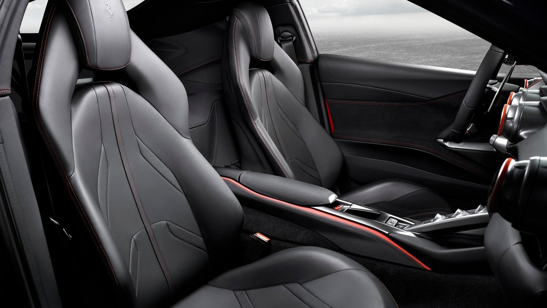 Image of the interior of the Ferrari 812 Superfast, showing the seats, dashboard, and steering wheel from the passenger side