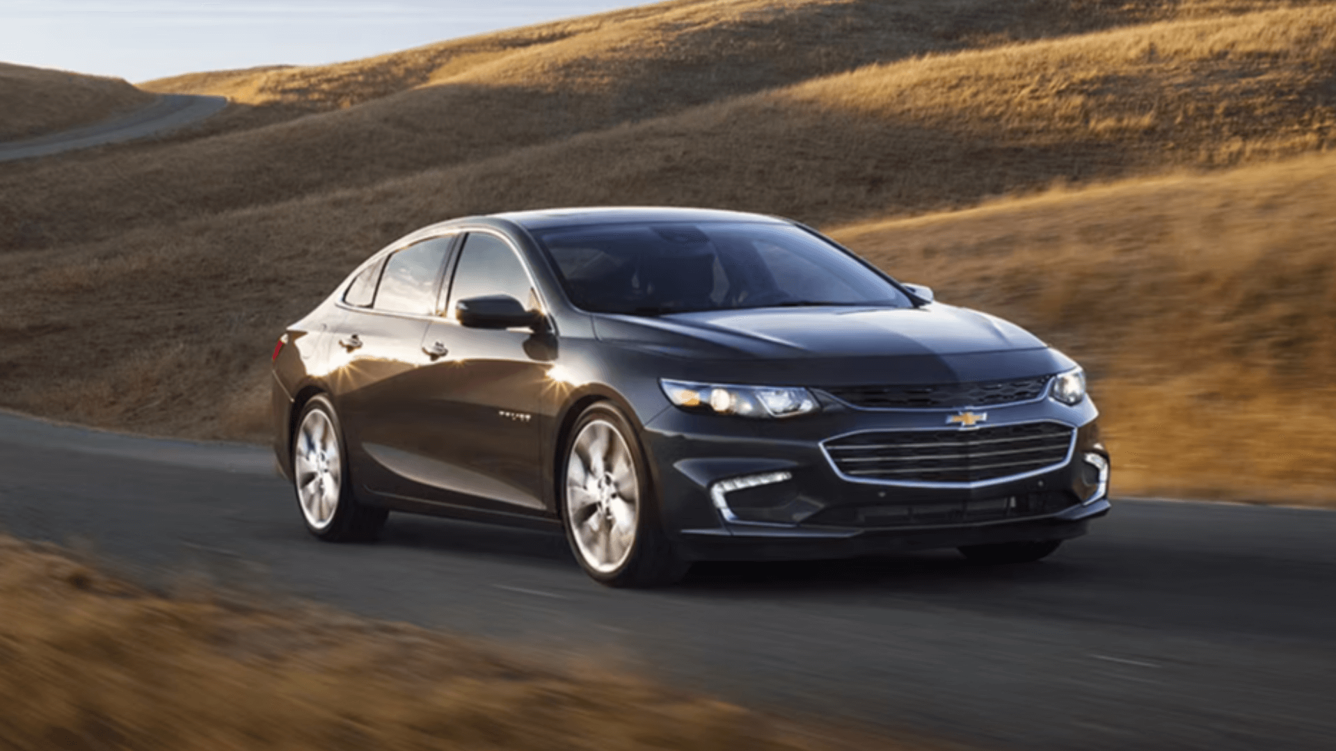 Black 2017 Chevrolet Malibu on a scenic rustic road