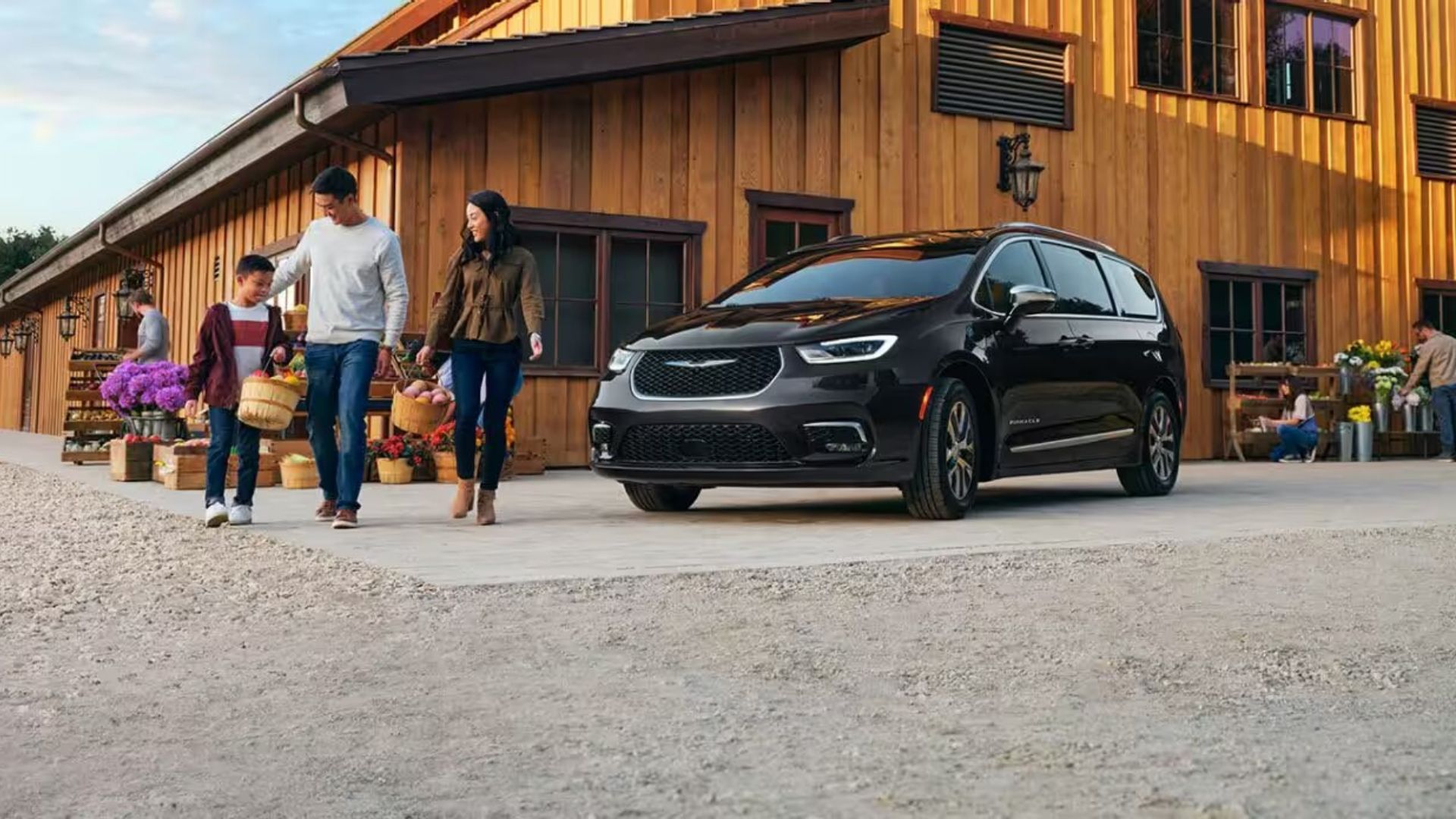 2023 Chrysler Pacifica Hybrid Minivan parked infront of a cabin