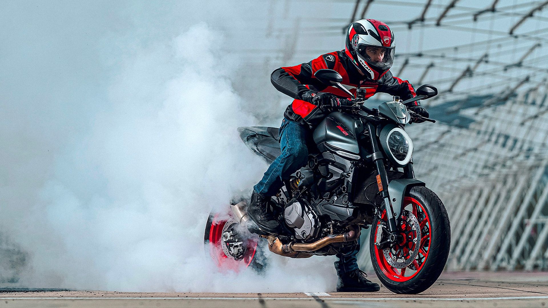 Gray 2024 Ducati Monster 937 Plus doing a burnout