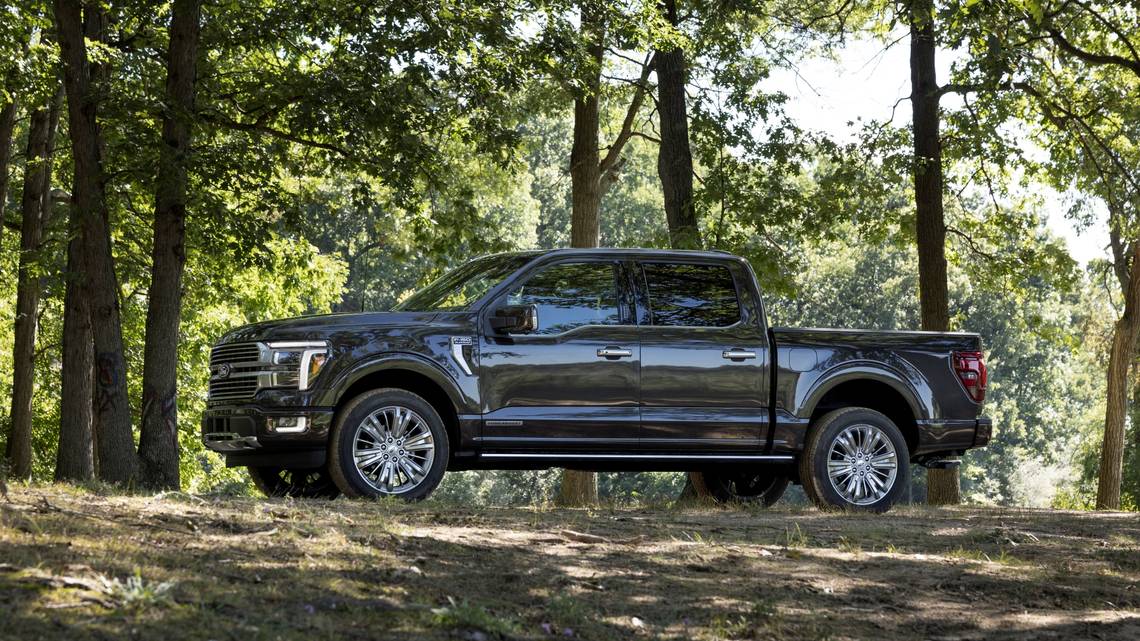 A two-year-old hybrid pickup truck parked in a wooded area, showcasing its sleek design and rugged build