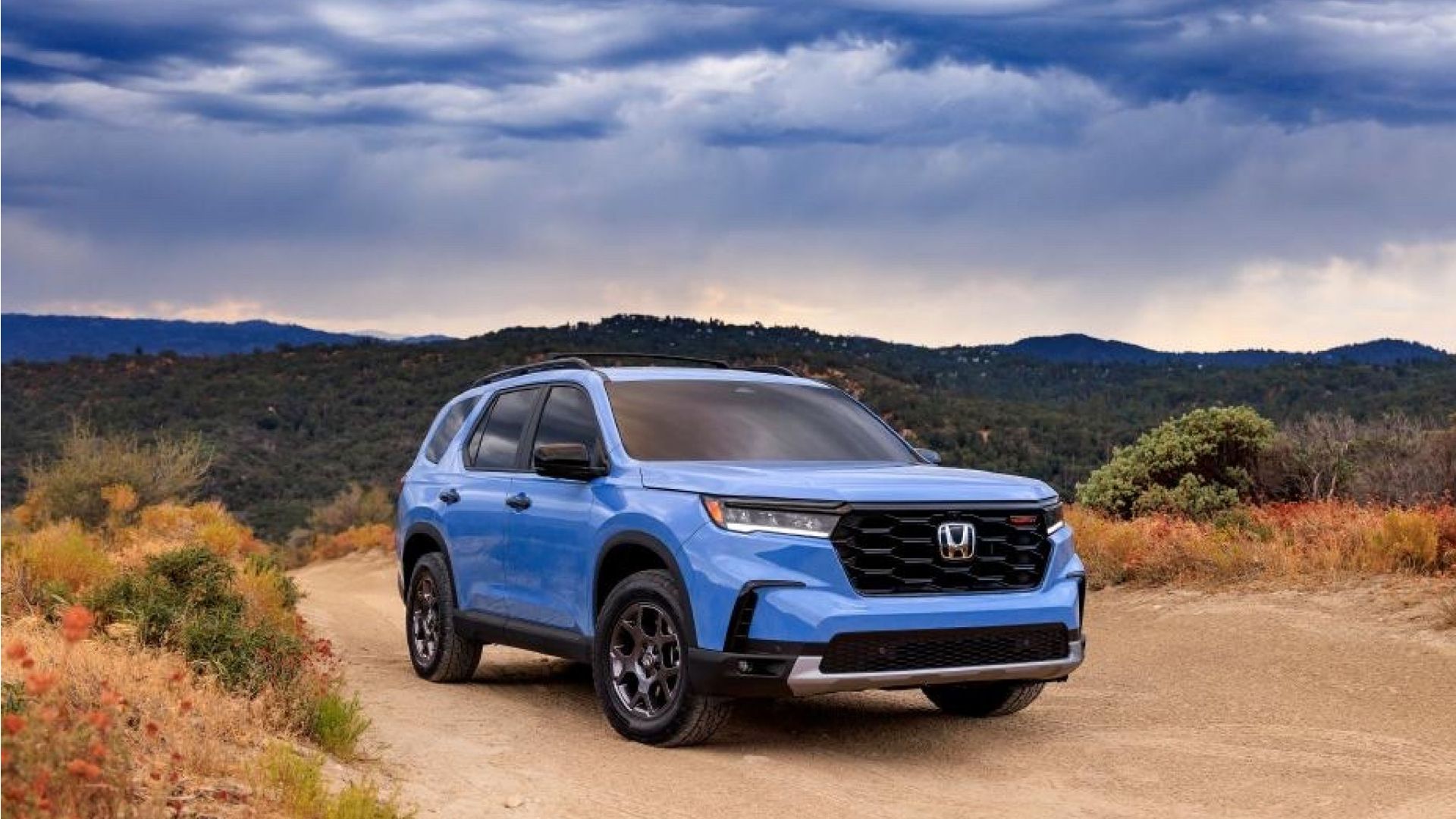 2023 Honda Pilot SUV - vista frontal e lateral direita - azul claro - estrada rural/de terra - off-road
