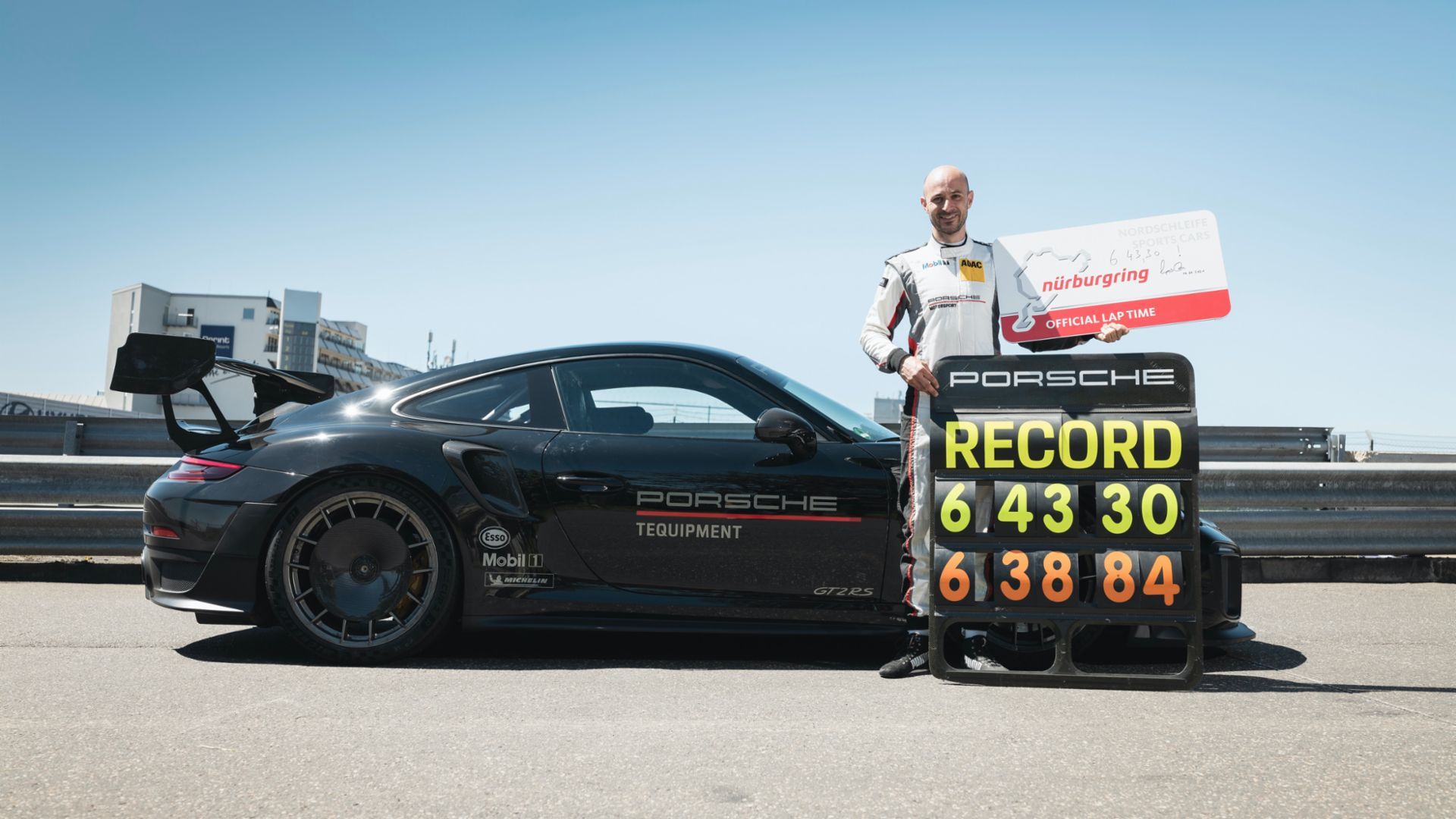 O piloto de testes Lars Kern na frente do Porsche 911 GT2 RS 2021 exibindo seus dois tempos recordes com o carro