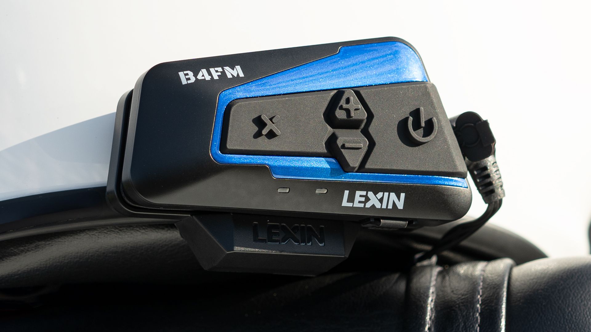 Closeup shot of a LEXIN B4FM Motorcycle Bluetooth Headset on a motorcycle helmet.