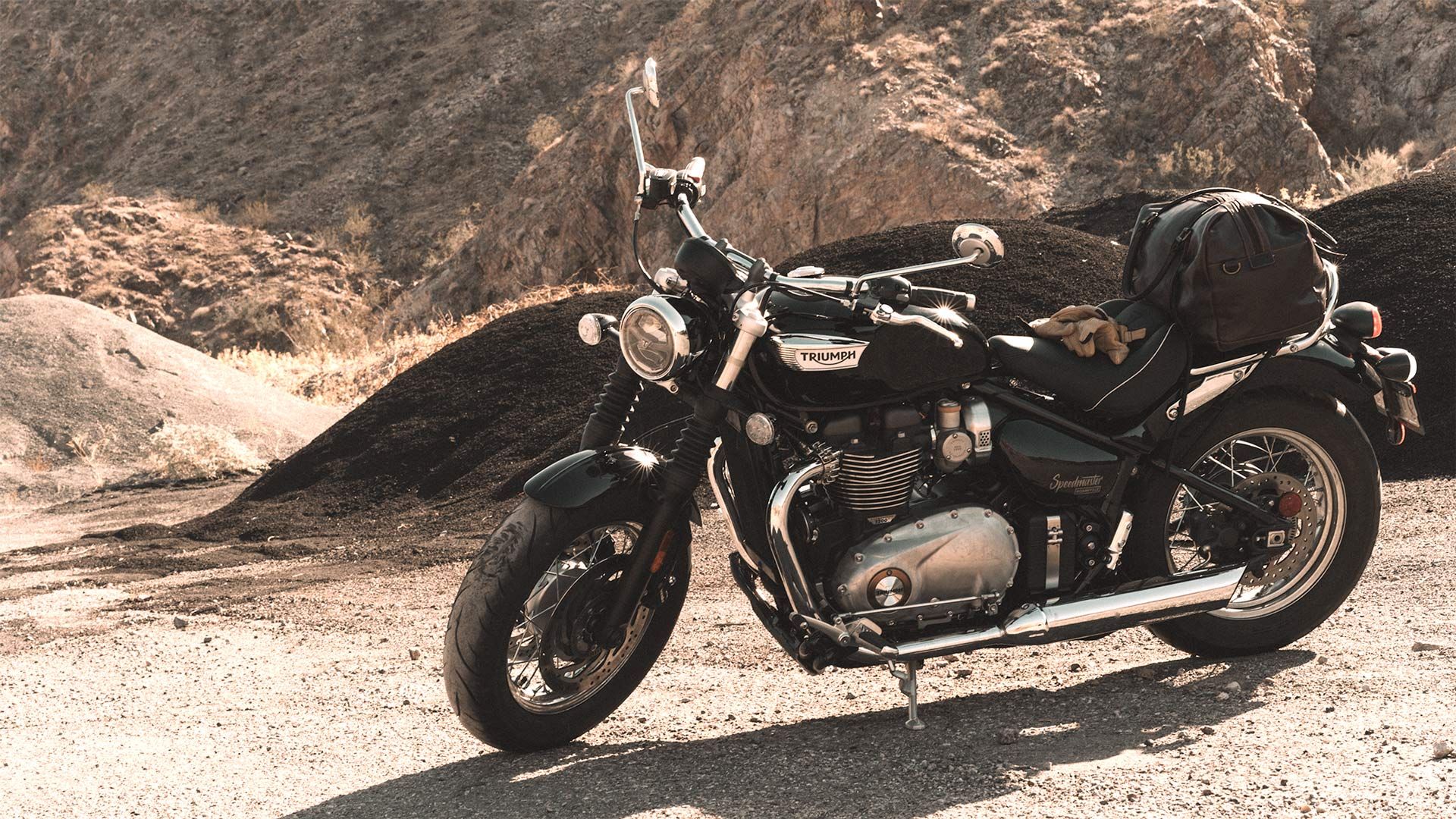 A 2023 Triumph Bonneville Speedmaster parked in a desert canyon.