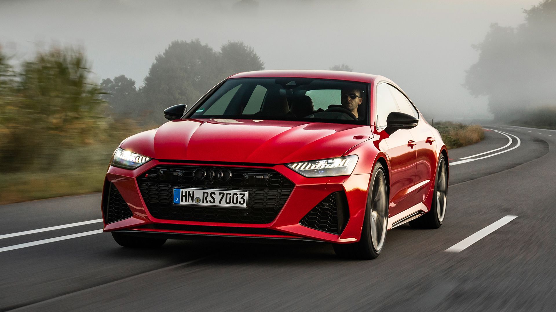 Red 2024 Audi RS7 Sportback on the road