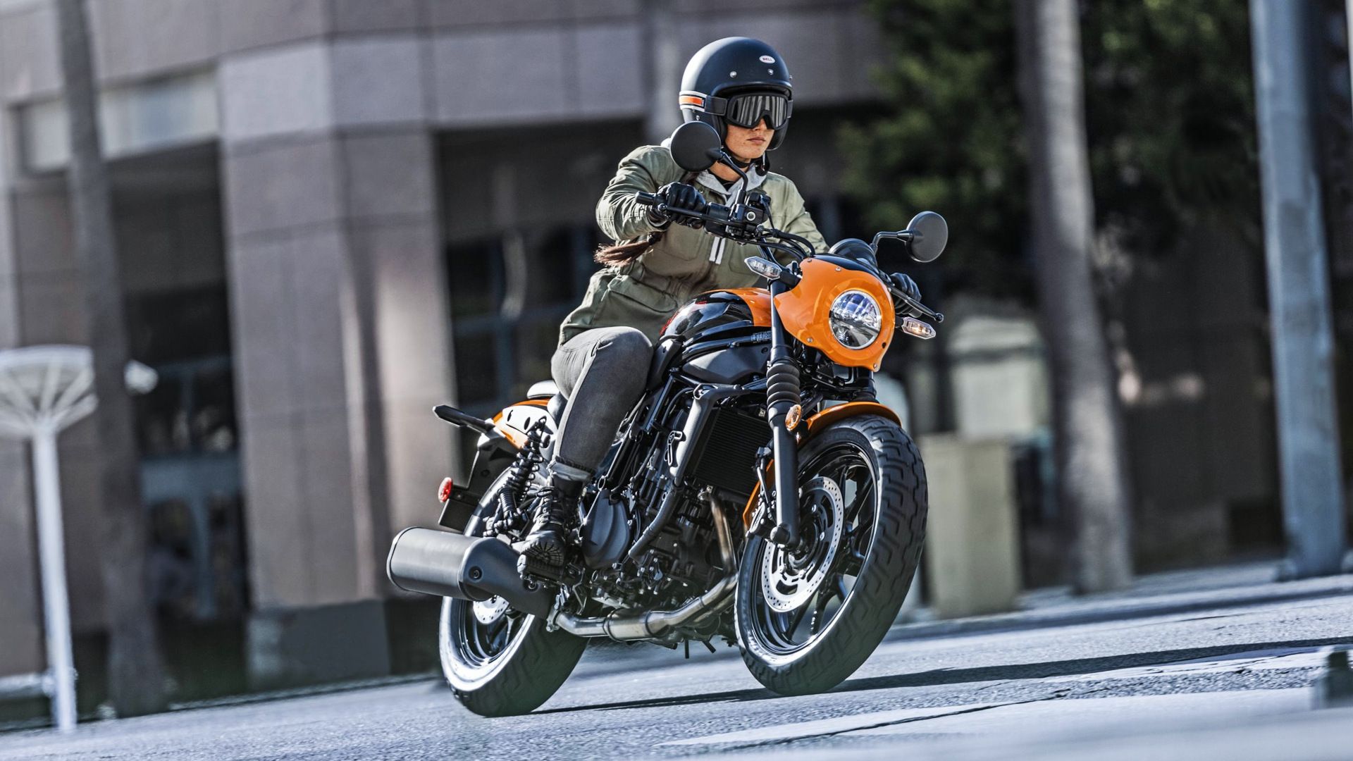 Orange 2024 Kawasaki Eliminator SE cruising through town