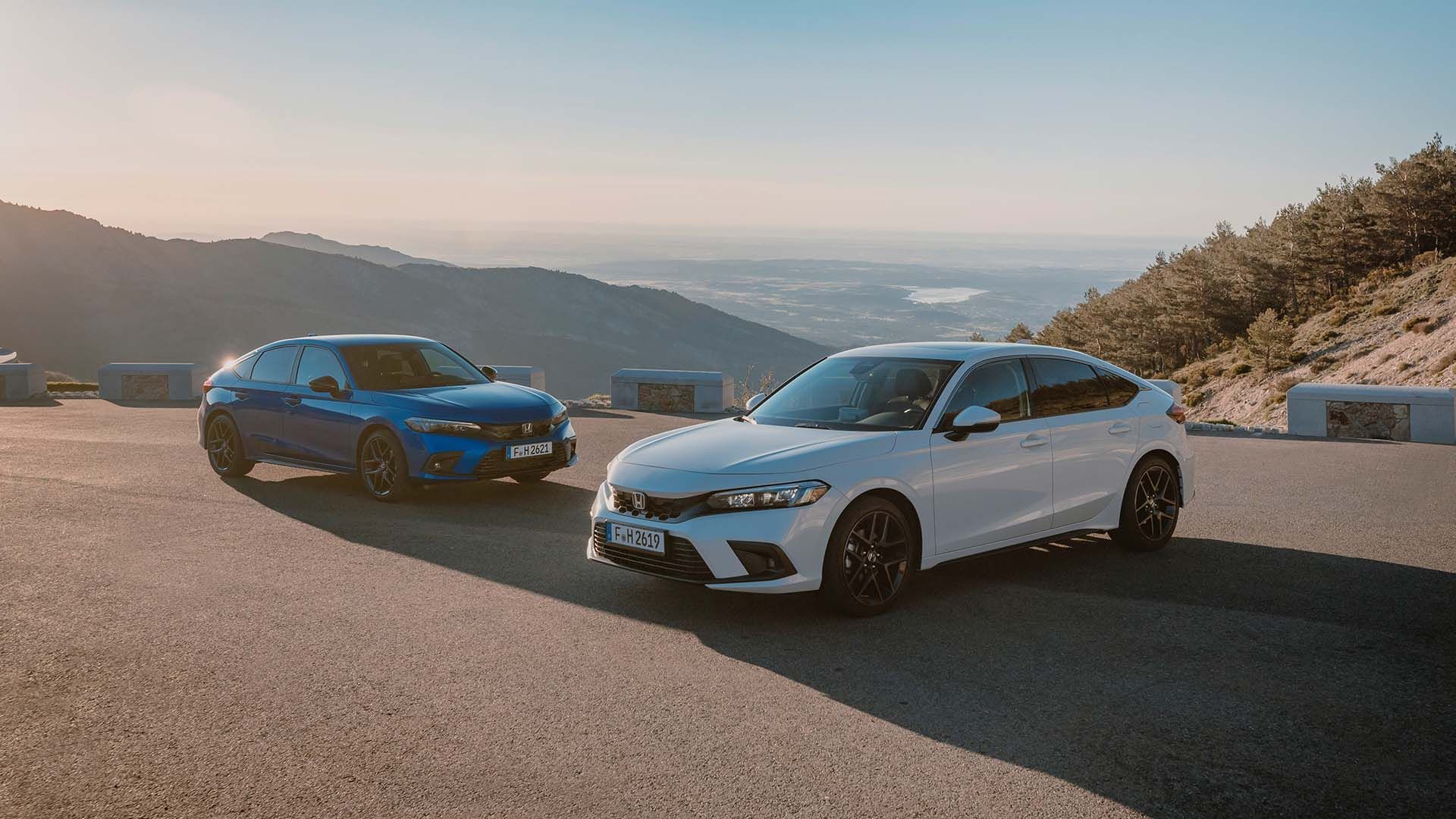 (Left-to-right) a blue and white 2023 Honda Civic Hybrid