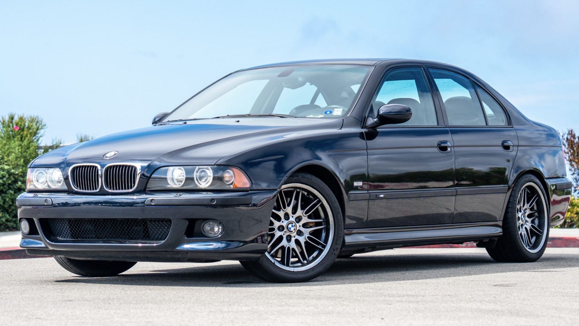 2003 BMW M5 in black posing in parking lot