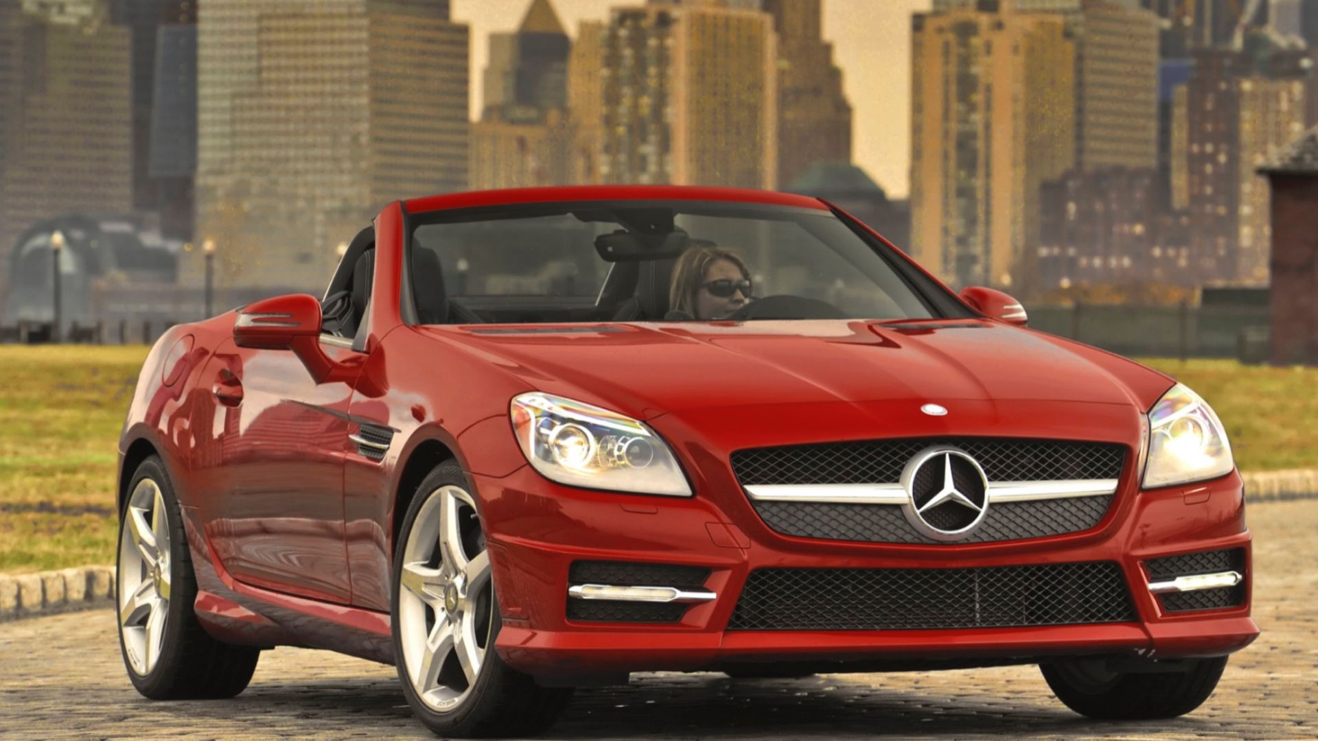 2016 Mercedes-Benz SLK in red posing in front of city scene