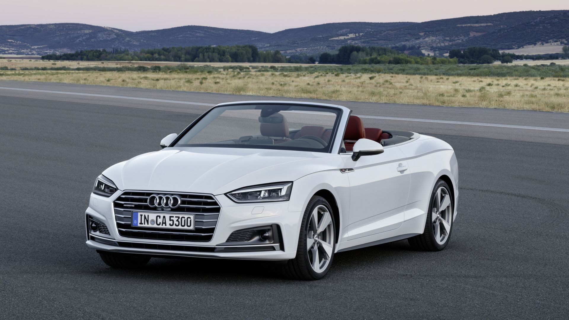 2018 Audi A5 Cabriolet in white posing in front of mountains