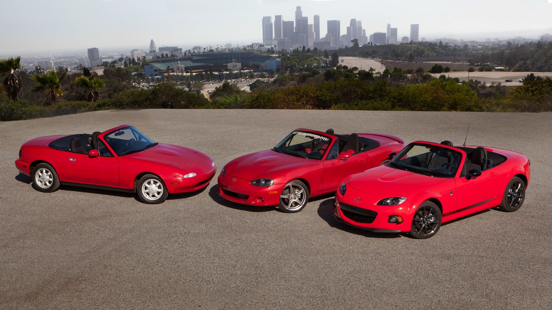 Three red Miatas from three different years