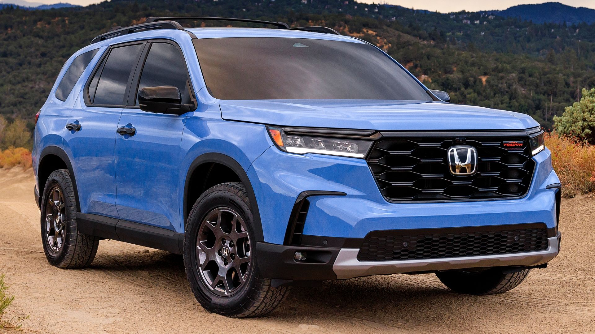 2023 Honda Pilot TrailSport in Diffused Sky Blue Pearl color on an off-road trail