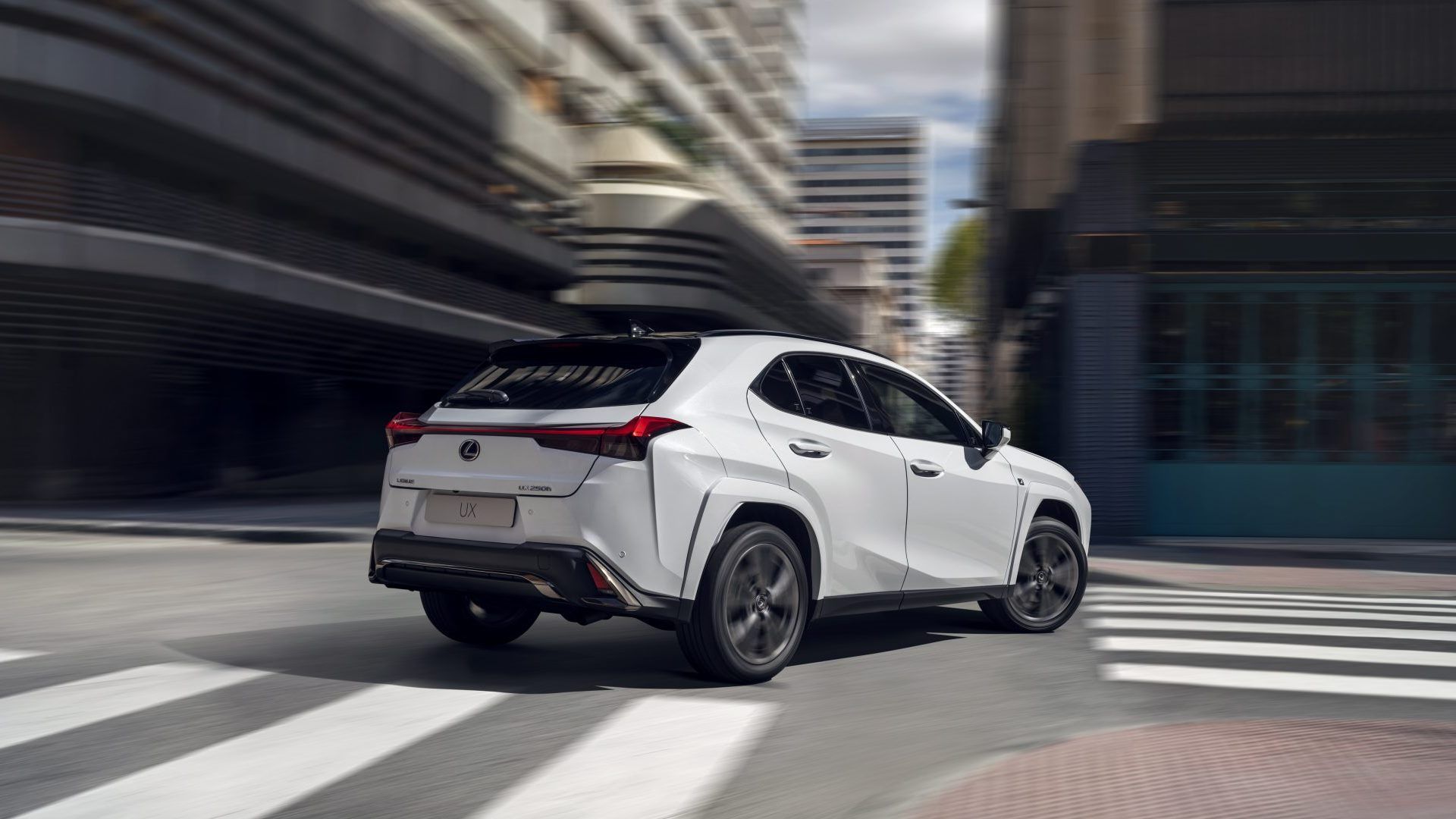 A rear, right hand-side, perspective shot of a 2024 Lexus UX 250h F Sport
