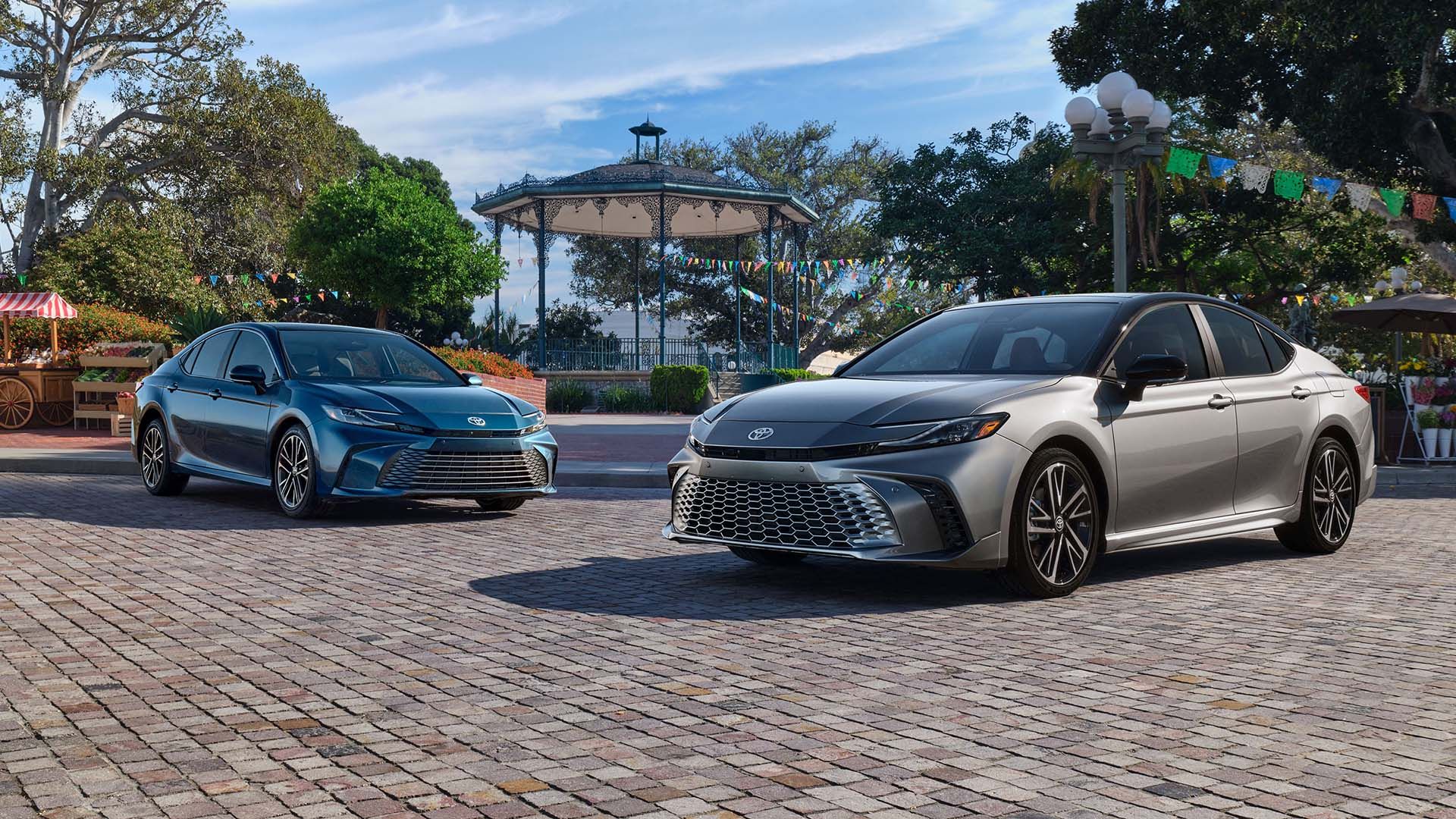 A group shot of the 2025 Toyota Camry XLE on the left and XSE on the right