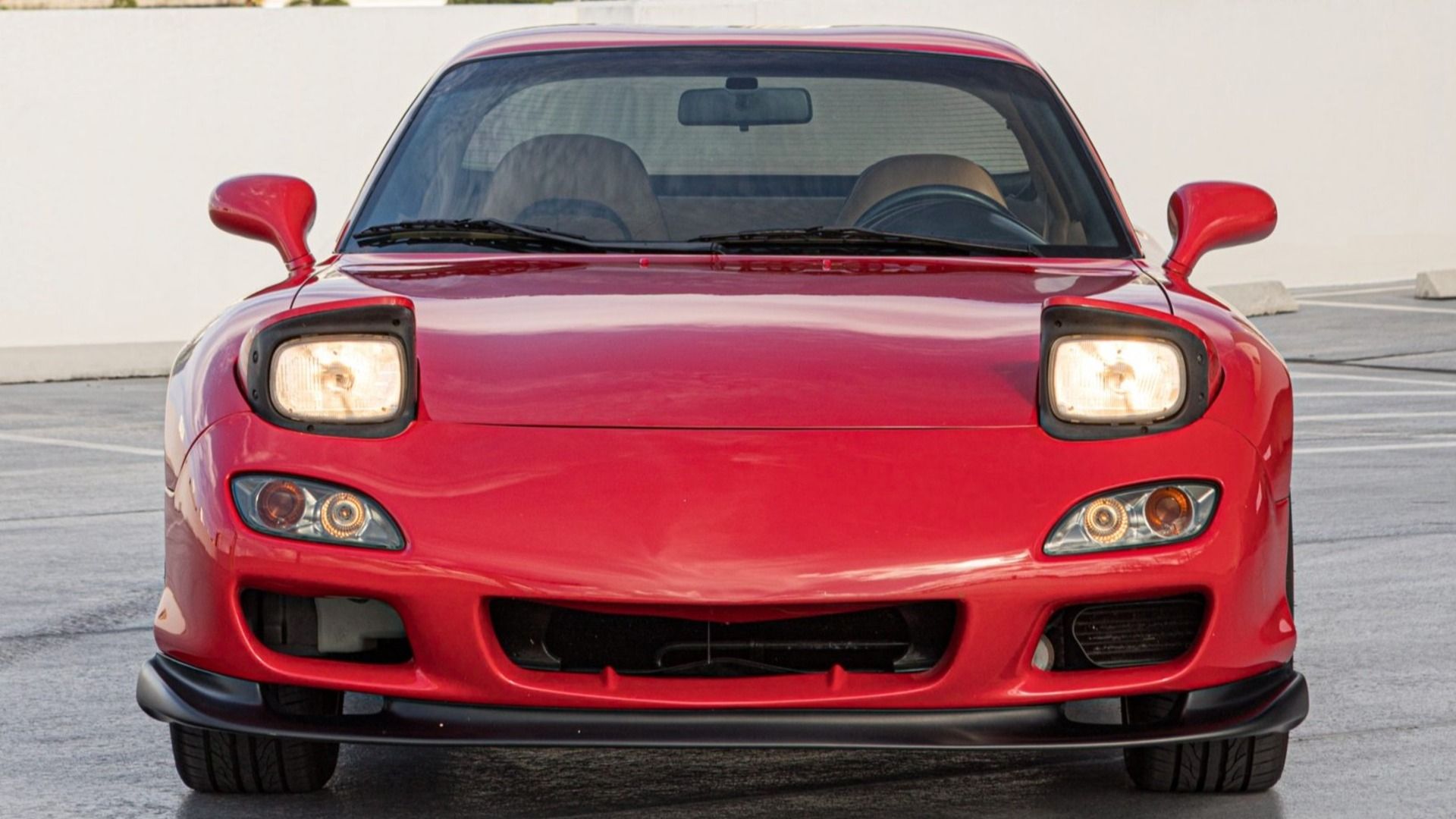 1993 Mazda RX-7 is finished in red over tan leather upholstery and powered by a twin-turbocharged 1.3-liter rotary