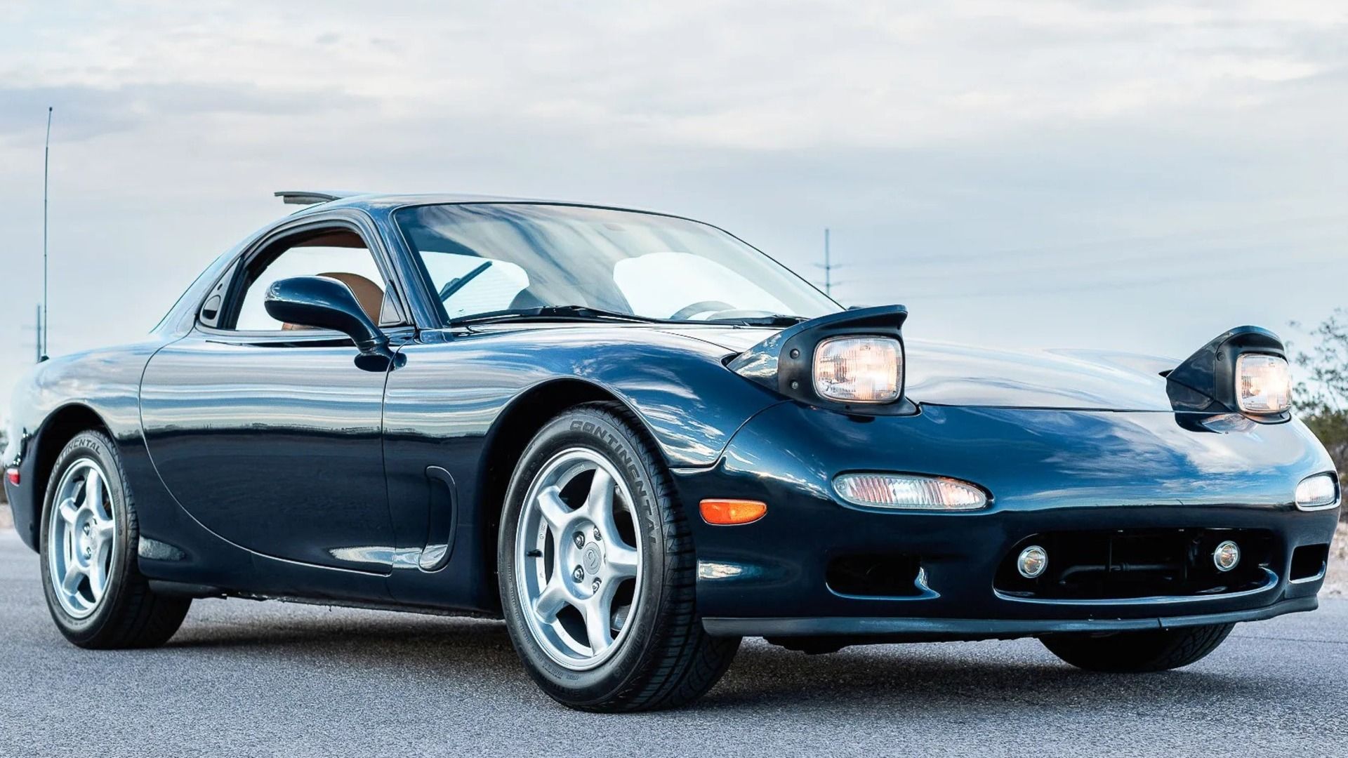 A blue-green 1993 Mazda RX-7 Touring 5-Speed