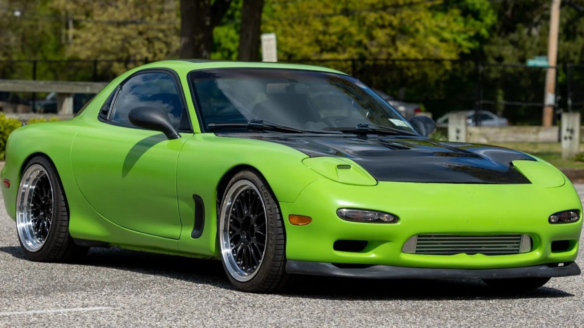 A modified bright green 1994 Mazda RX-7 5-Speed