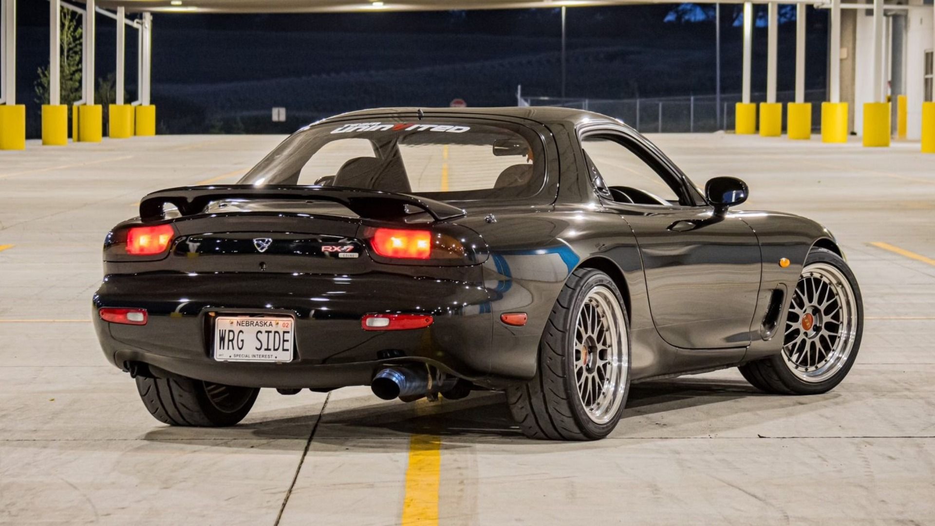 A black 1992 Mazda Efini RX-7 Type R 5-Speed with a few modifications.