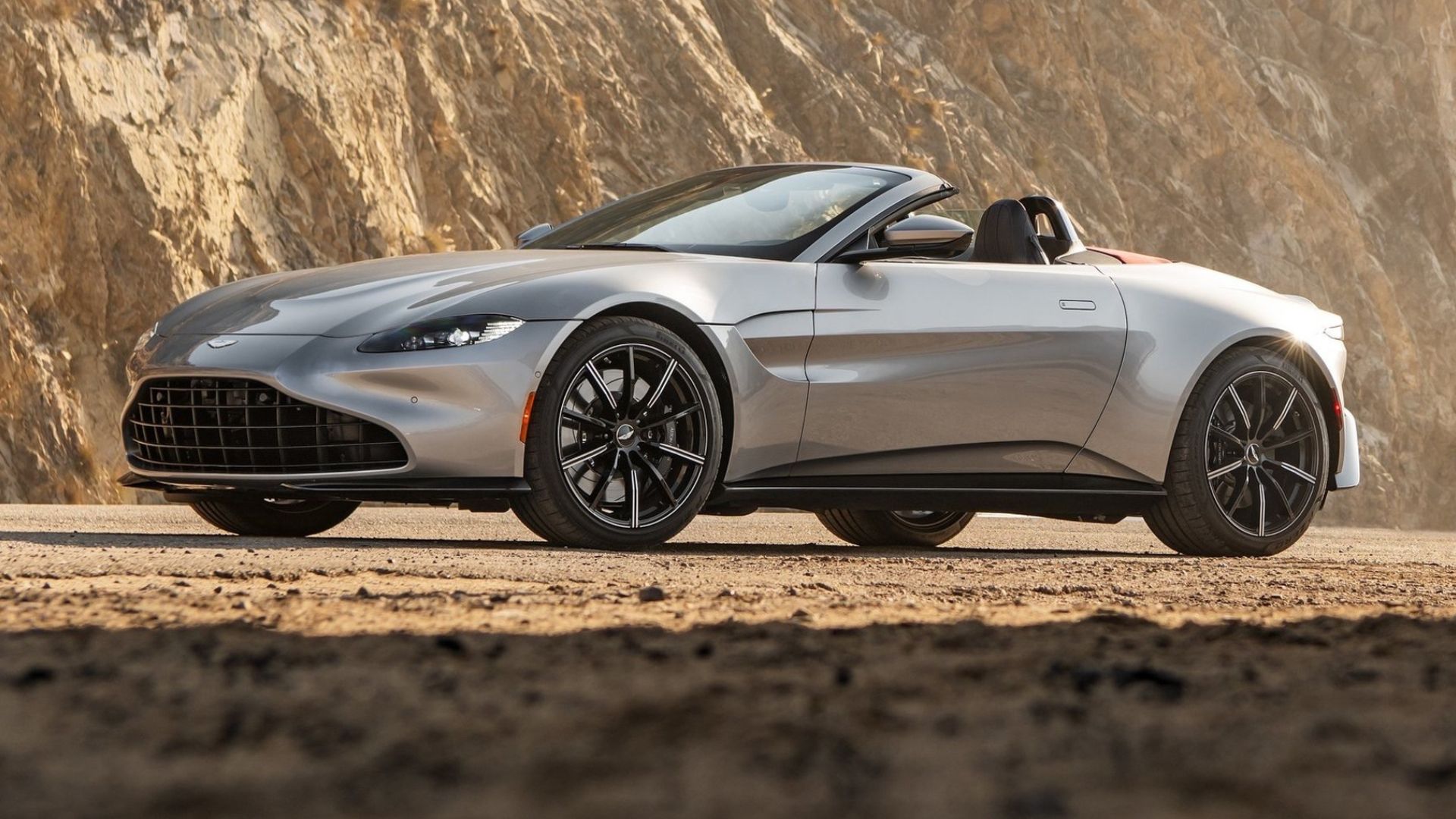 2021 Aston Martin Vantage Roadster in silver posing in front of cliffs