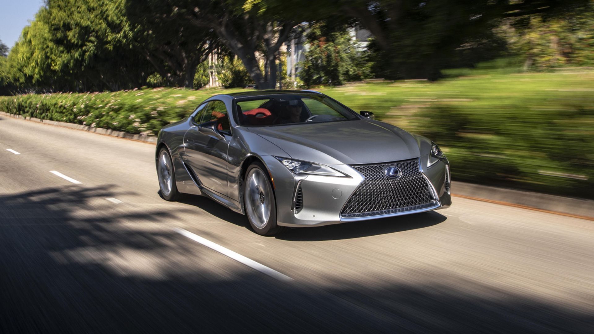 2023 Lexus LC500H in silver driving on town road