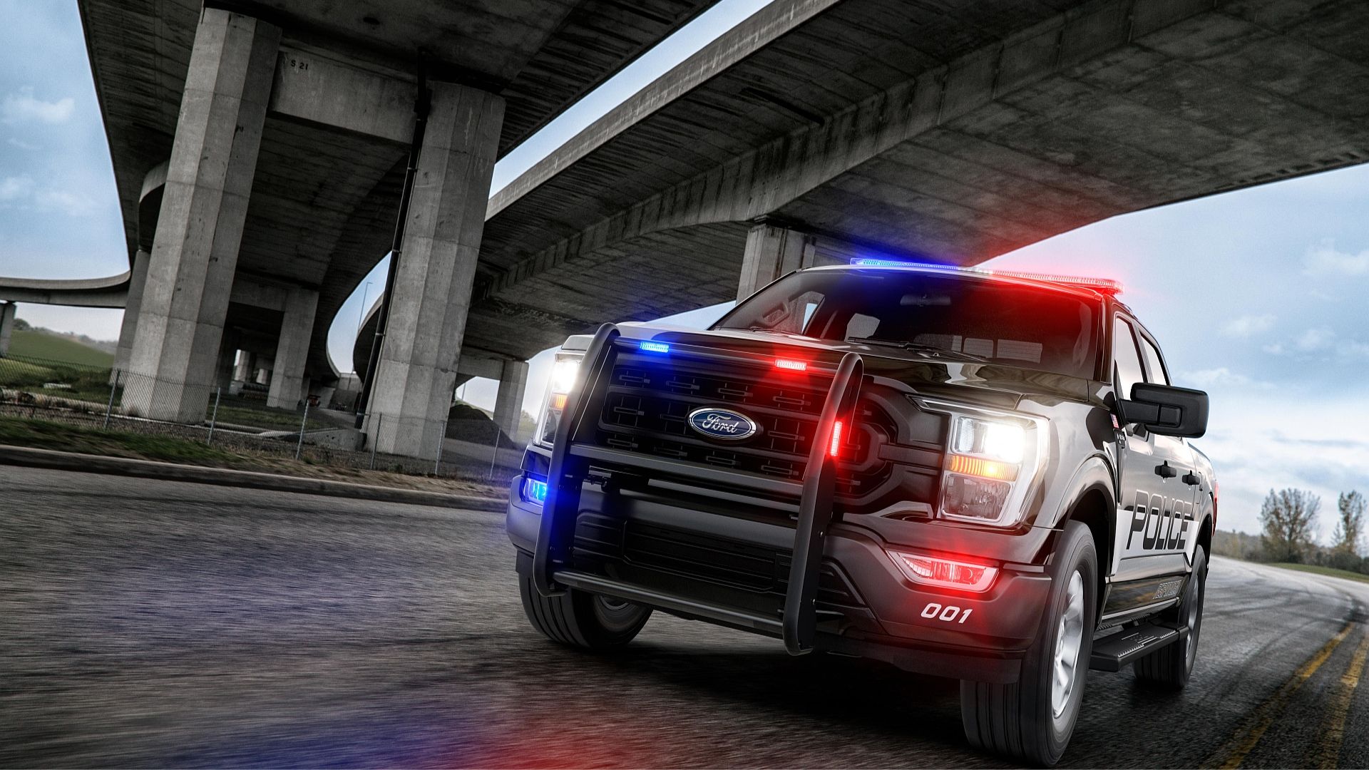 2021 Ford F150 Police Responder driving under a highway overpass