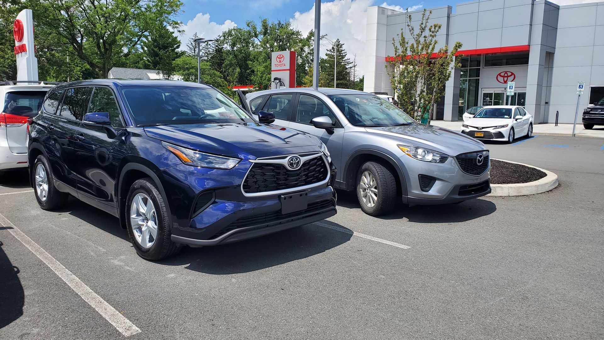 2022 Toyota Highlander and 2016 Mazda CX5 outside dealership