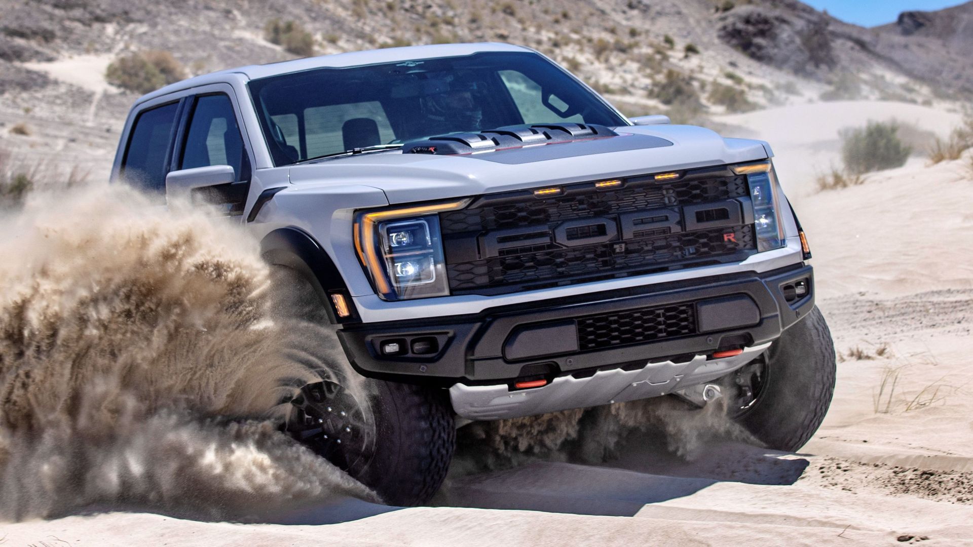 Close up shot of the front of a 2023 Ford F-150 Raptor R accelerating