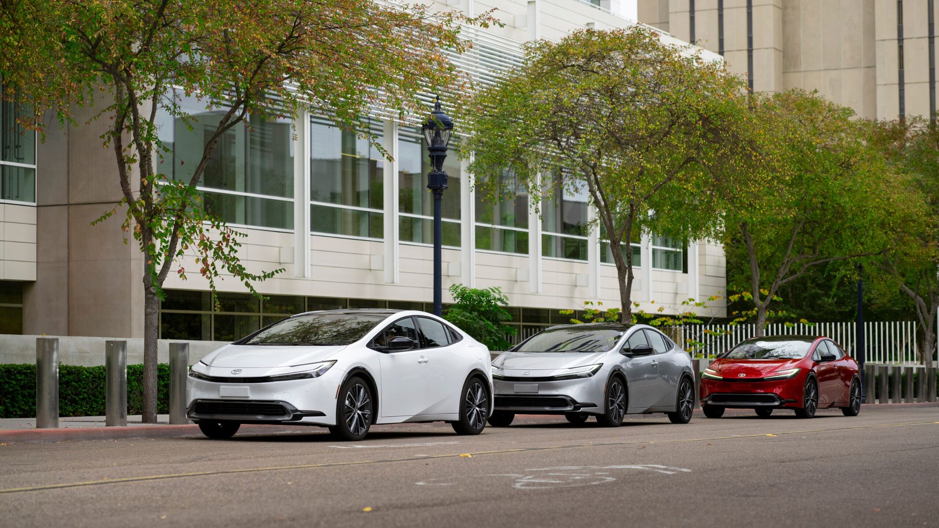  Three Toyota Prius vehicles parked in a row on a city street