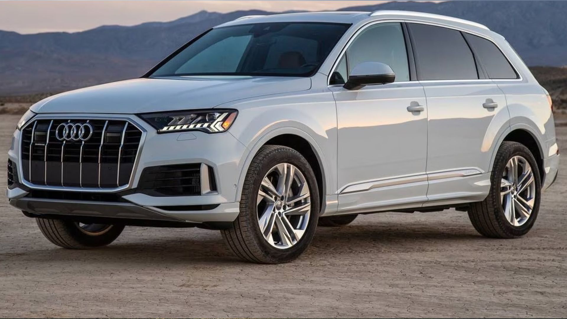 2024 Audi Q7 in white posing in desert with mountains n background