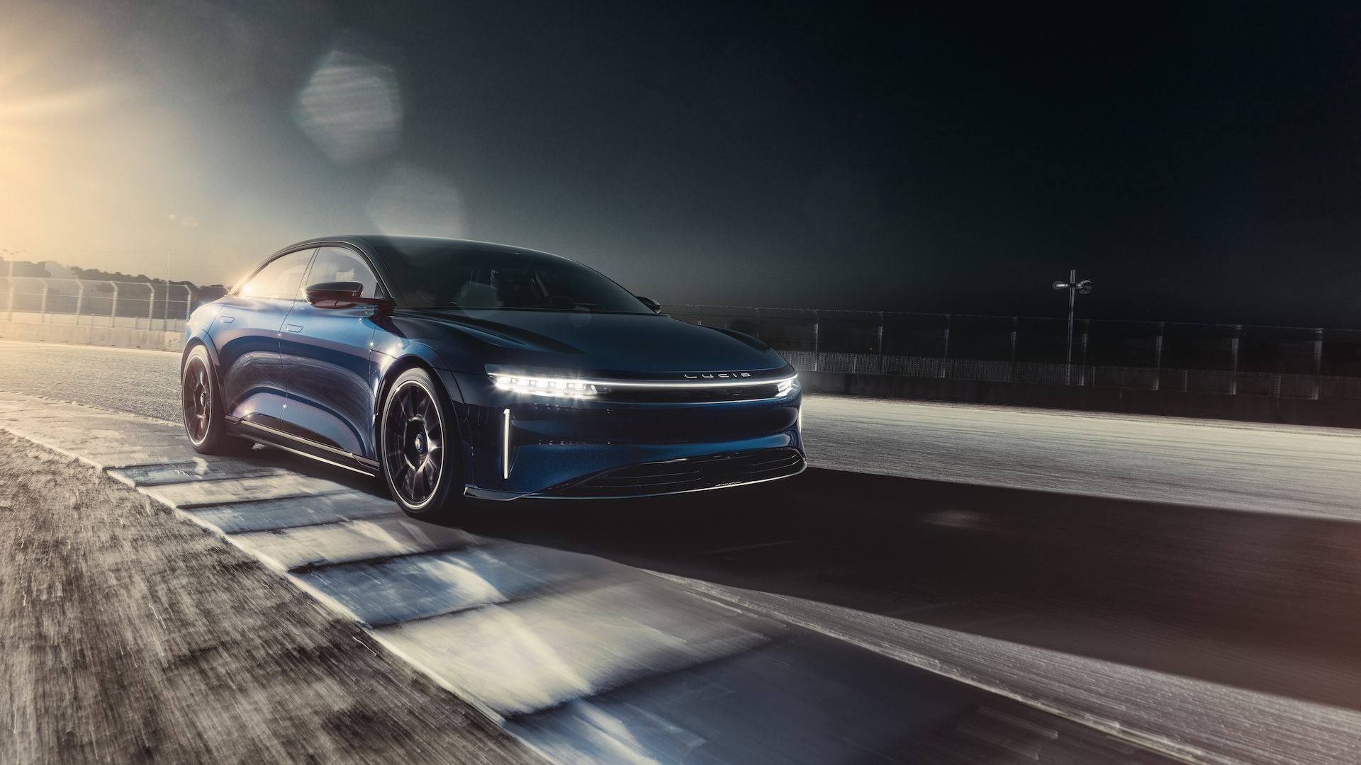 A blue-colored Lucid Air Sapphire hitting the apex on a racetrack