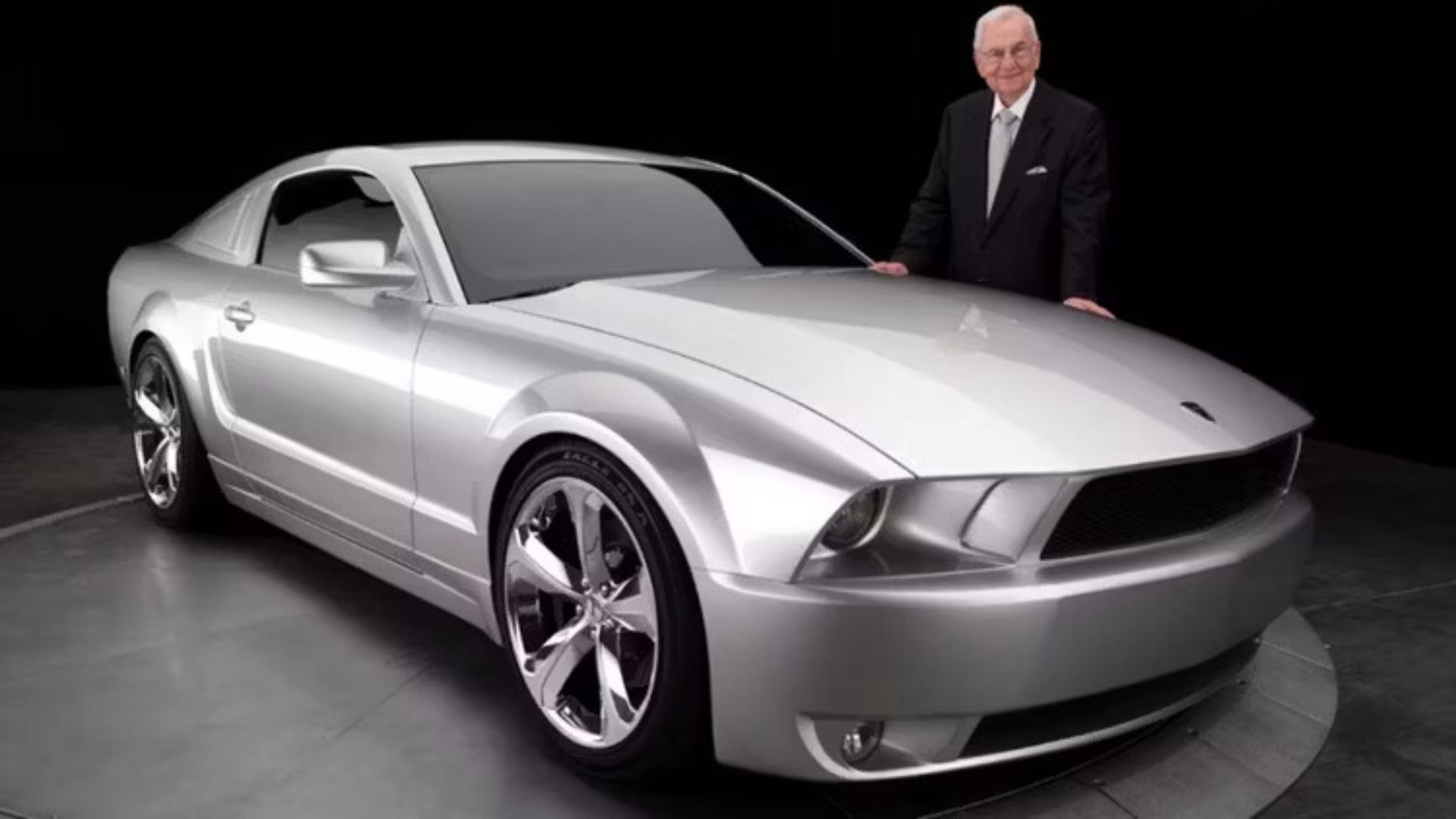 Lee Iacocca standing next to the 2009 Ford Mustang Iacocca Edition he designed