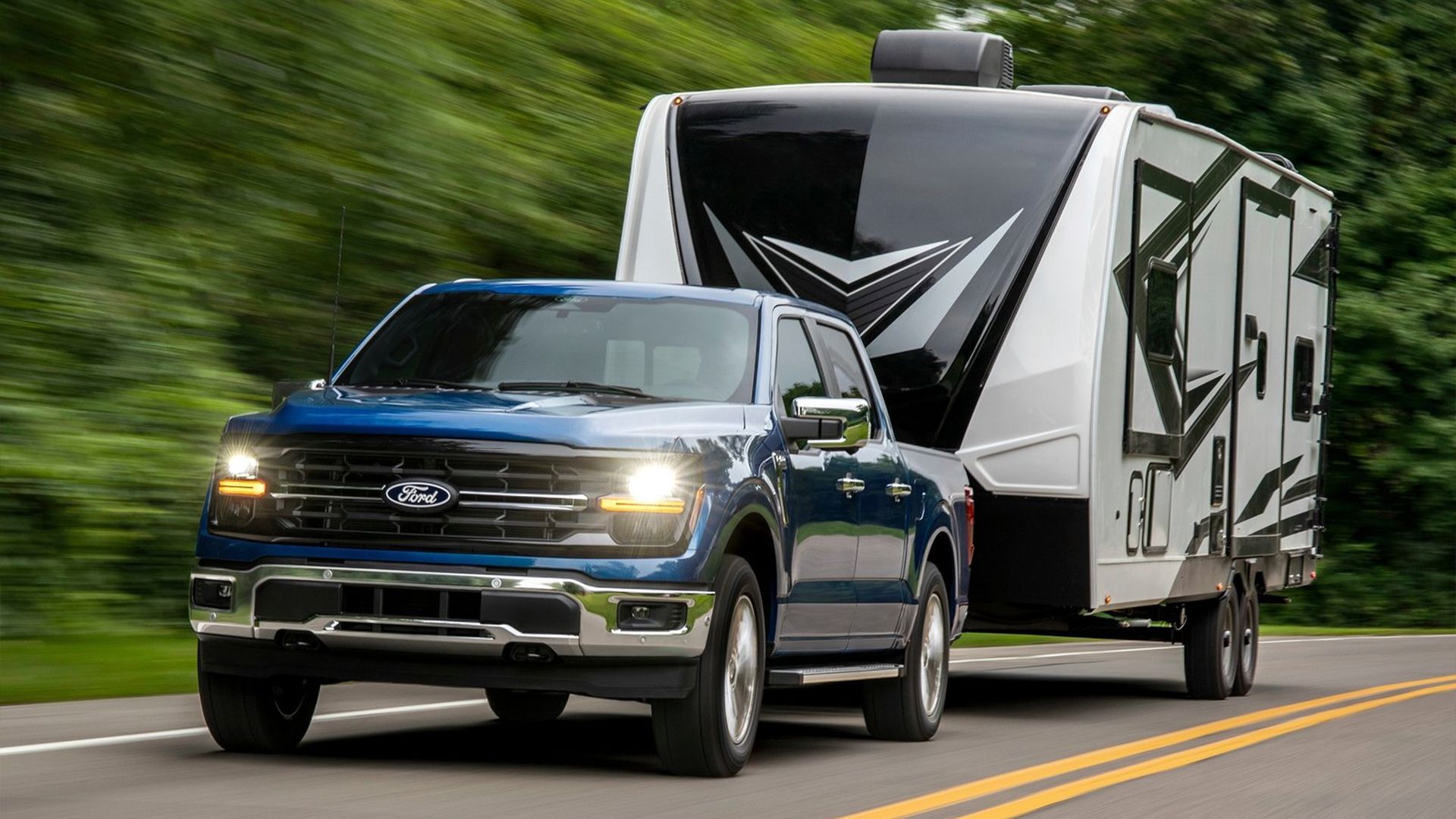 Front 3/4 shot of a 2024 Ford F-150 towing a trailer