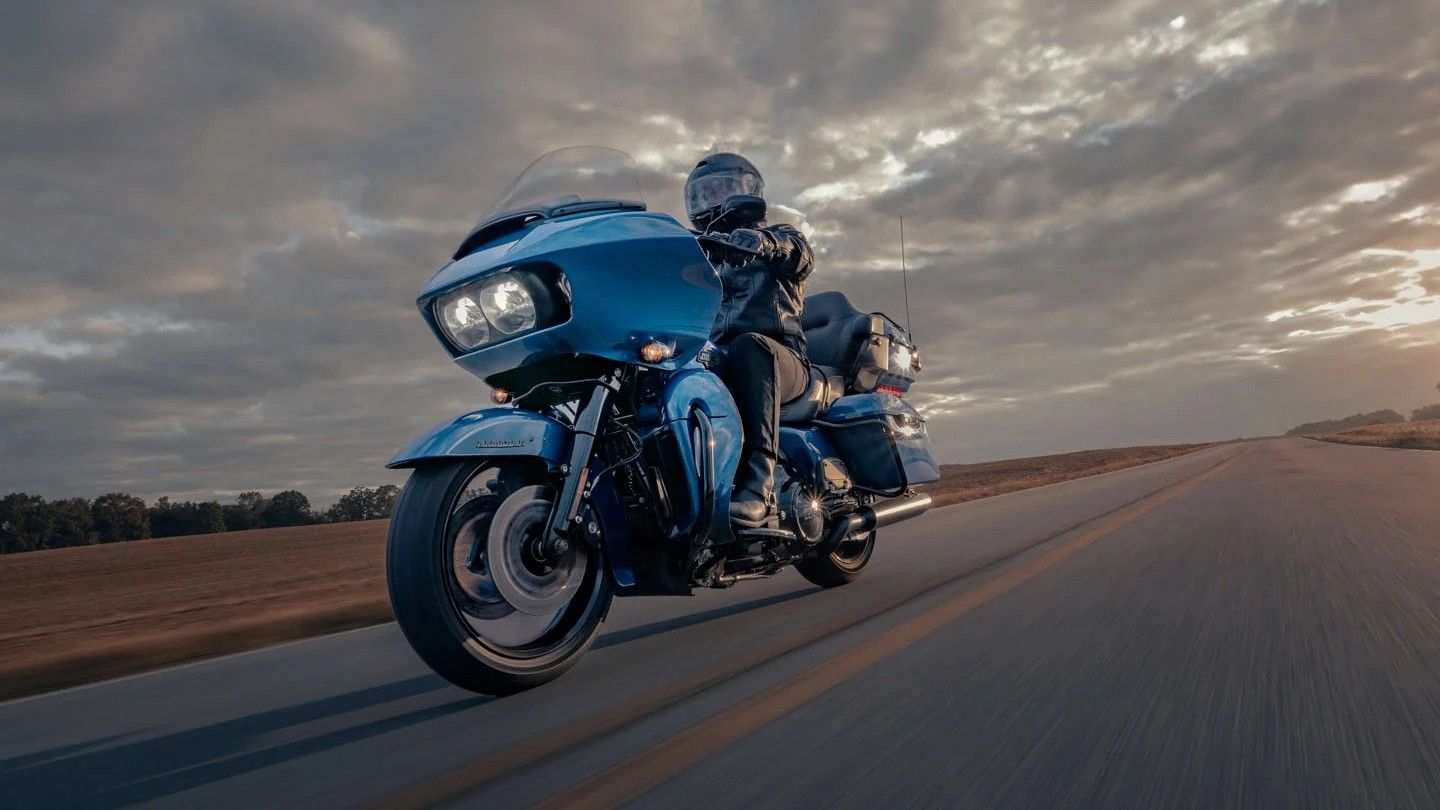 2024 Blue Harley-Davidson Road Glide Limited action shot cruising down highway. 