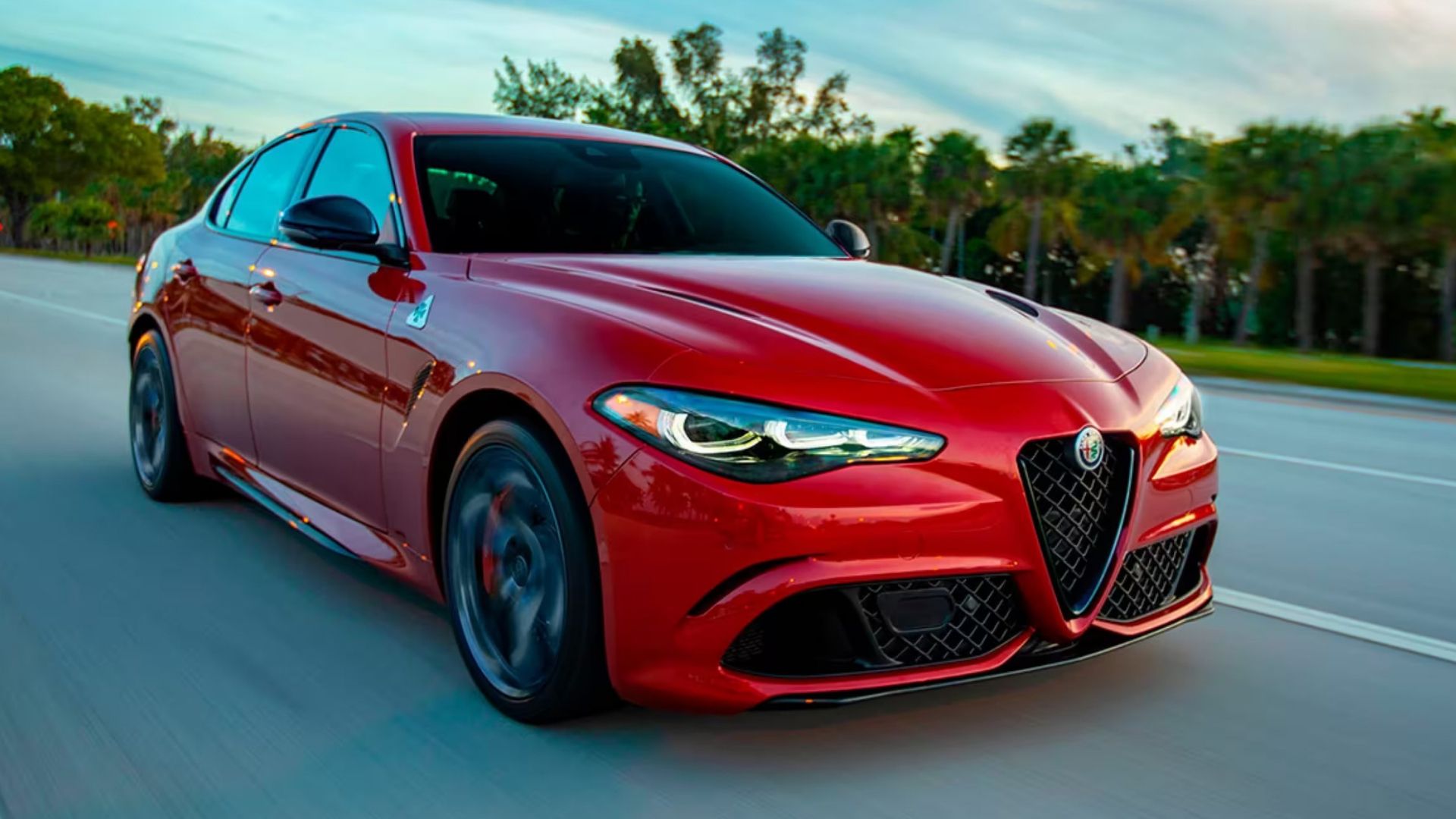 2024 Alfa Romeo Guilia in red driving along highway