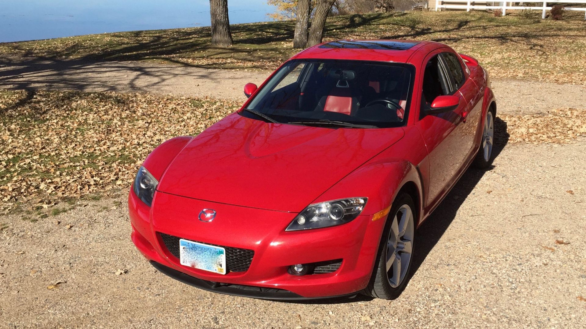2004 Mazda RX-8 in red posing in front of lake