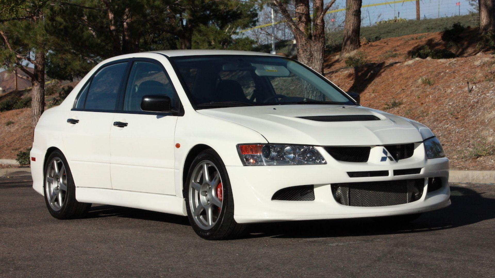 2004 Mitsubishi Lancer Evolution 8 in white posing in parking lot