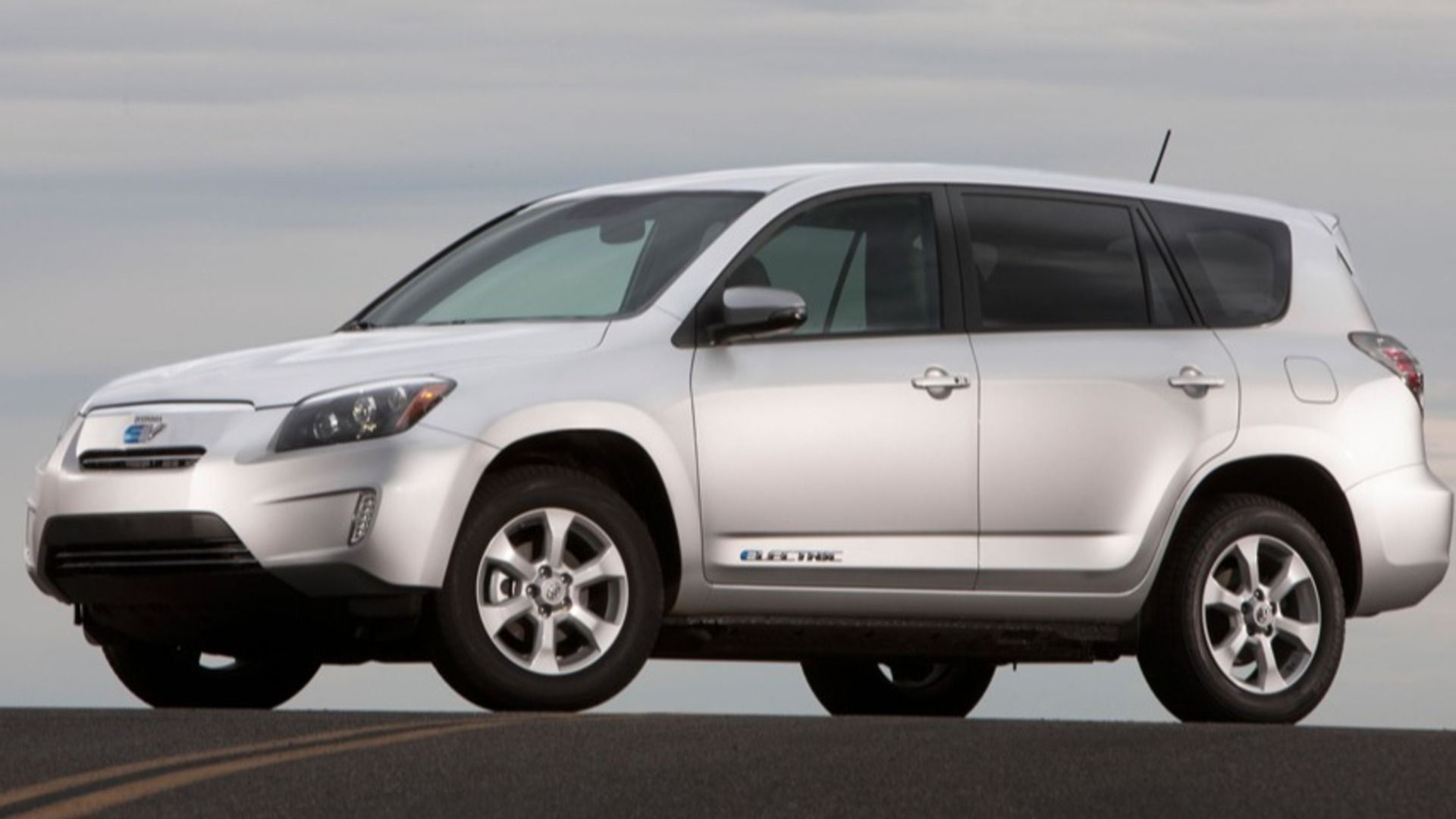 A forward-facing Toyota Rav4 EV in silver parked on a road
