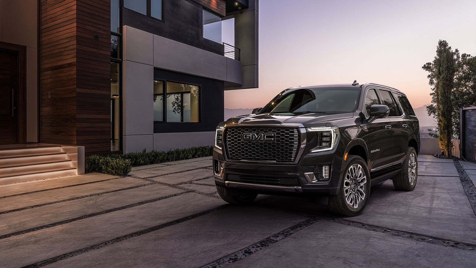 2023 GMC Yukon parked in front of a residential home