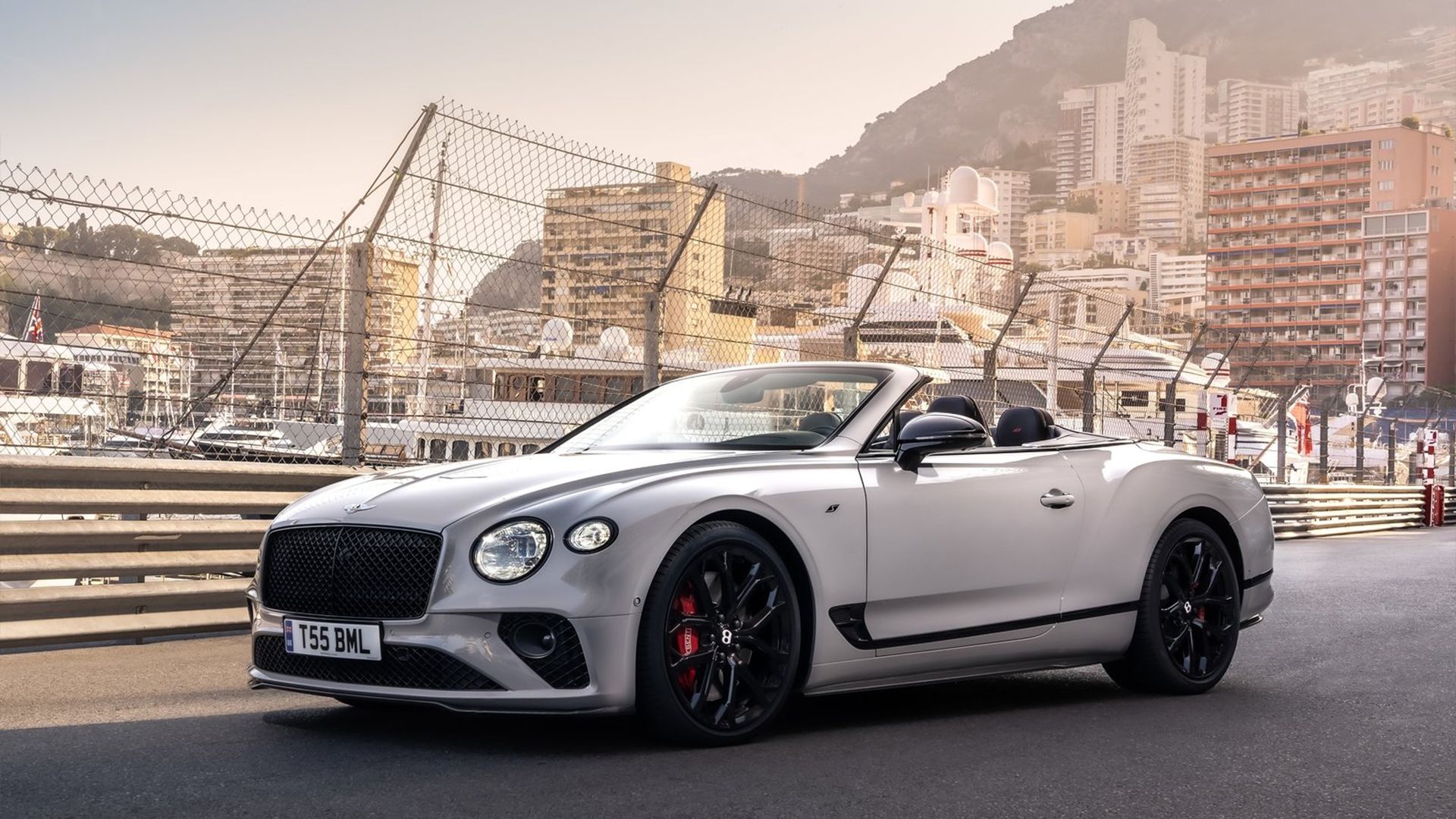 2024 silver Bentley Continental GTC in white posing in front of city scene