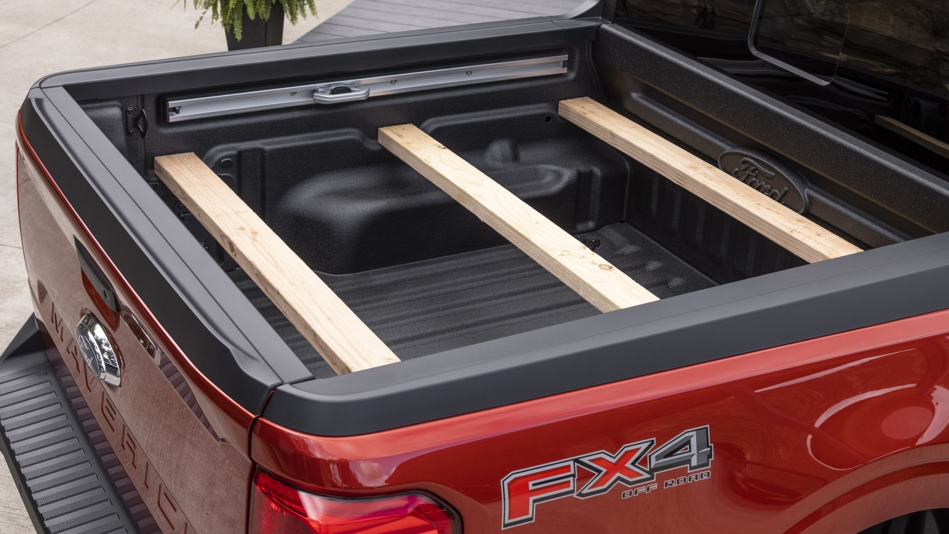 Truck bed of the 2024 Ford Maverick with 2x4s secured in the FLEXBED slots