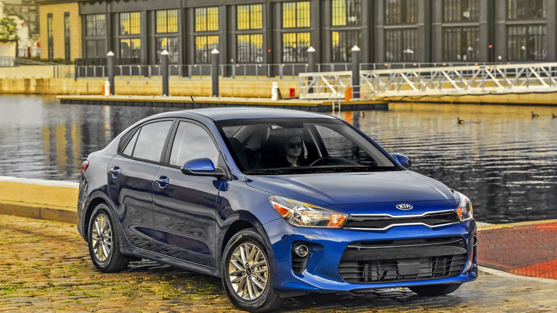 2019 Kia Rio in blue Posing in front of harbour