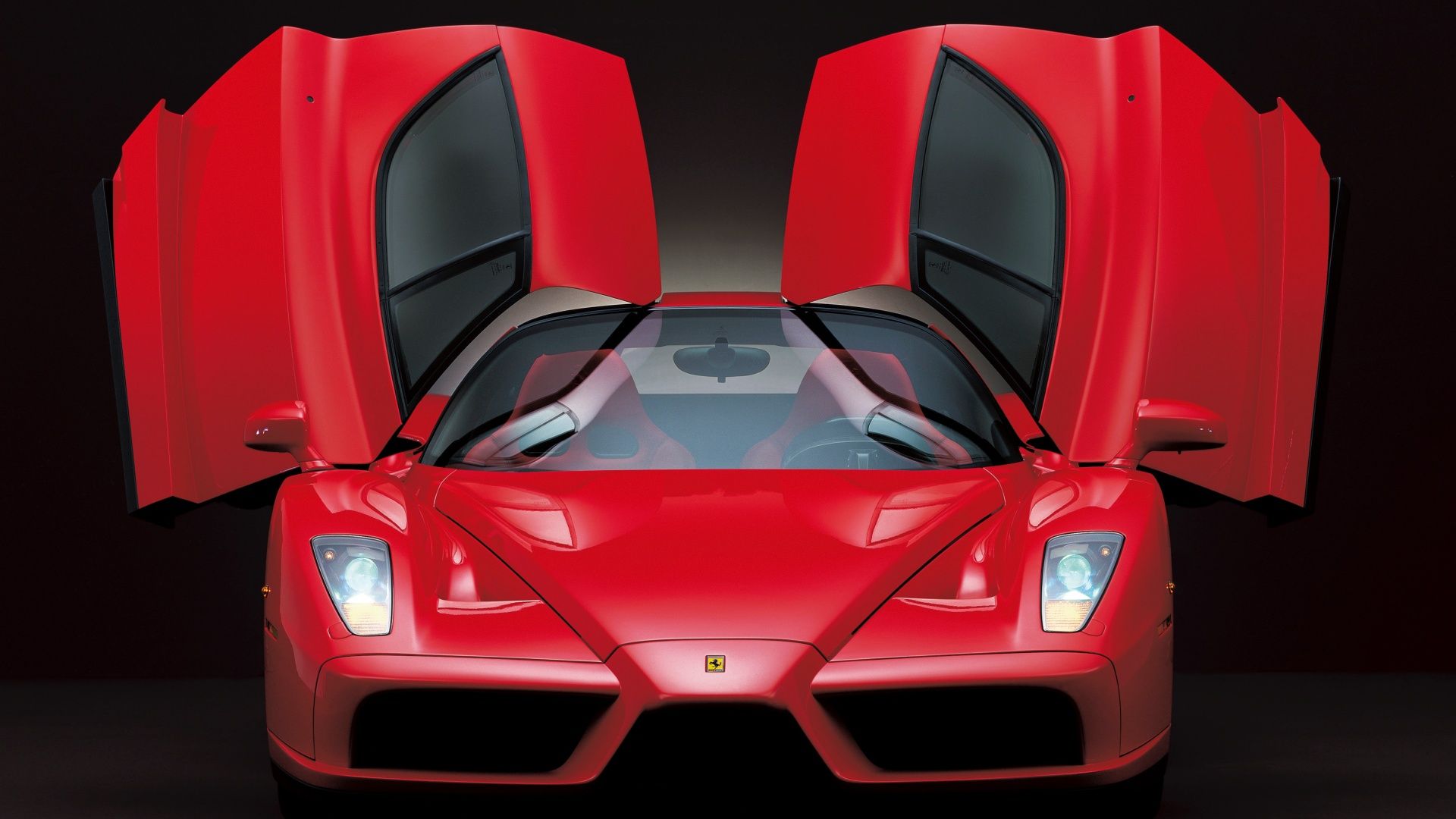 Red Ferrari Enzo, front on with doors open