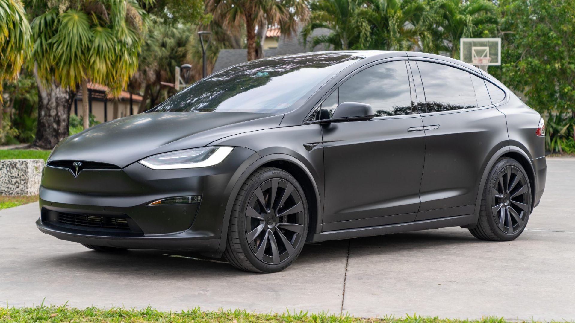 Front three-quarters shot of a matte black 2022 Tesla Model X Plaid. 