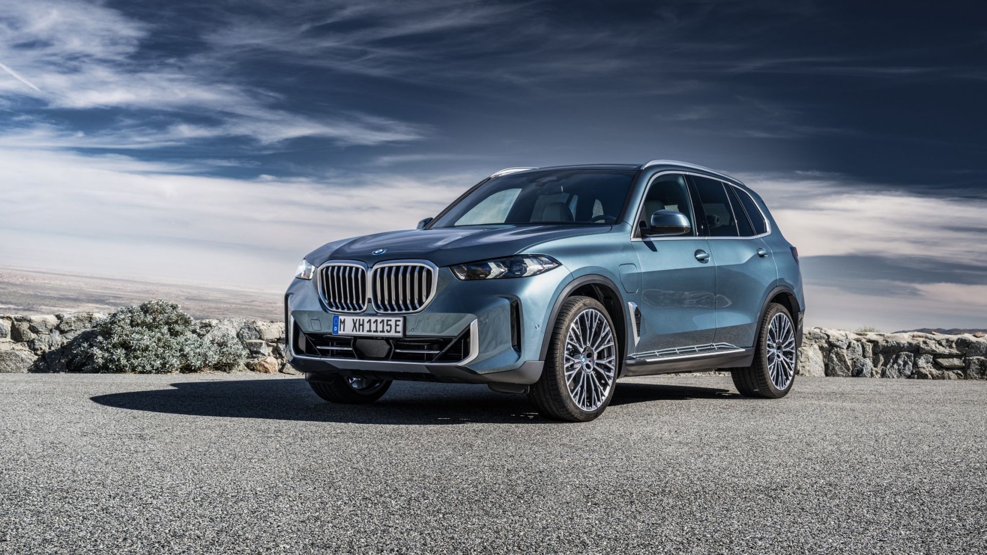 Front three quarter profile shot of an Aqua 2024 BMW X5 xDrive50e