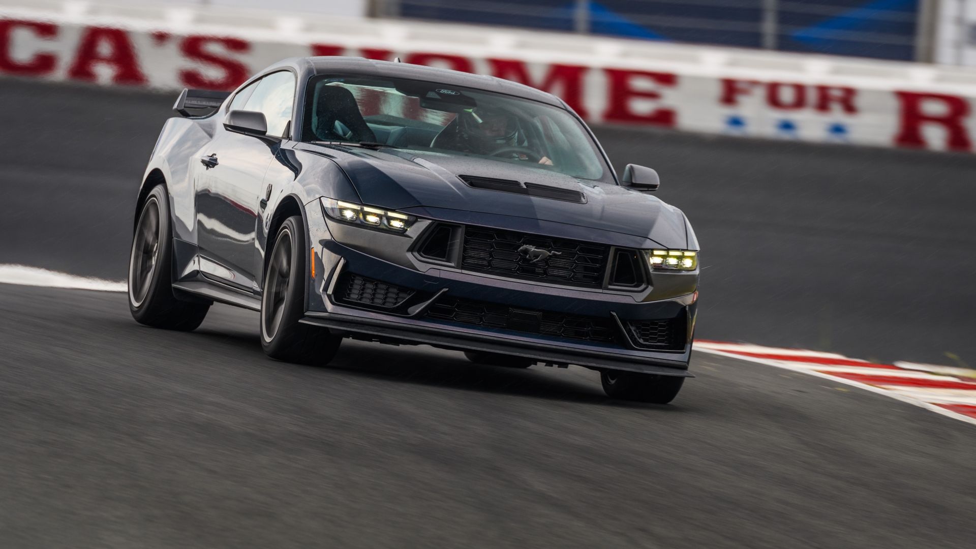 Front 3/4 shot of a 2024 Ford Mustang Dark Horse going around a track